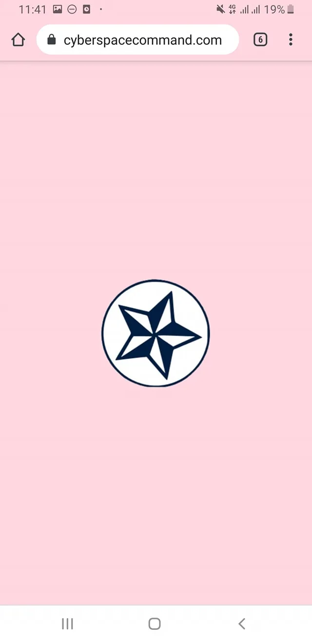 The image is a screenshot from a mobile device displaying a website with the URL "cyberspacecommand.com." The background is a soft pink color, and in the center is a circular logo containing a stylized navy blue star. The star is symmetrical with sharp edges, enclosed within a white circle outlined in navy blue. The screen captures the top part of a browser, showing the site address and browser controls, indicating a mobile view. The battery and connection indicators suggest the device is on low power with a 4G connection. The design is minimalist, focusing attention on the logo against the pink backdrop. No other details or text, apart from the URL, are visible on the screen.