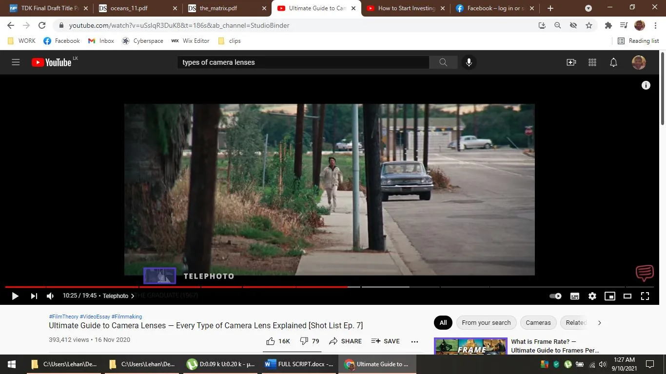 The screenshot captures a moment from a YouTube video titled "Ultimate Guide to Camera Lenses – Every Type of Camera Lens Explained [Shot List Ep. 7]" by StudioBinder. The image displays a scene from the film "The Graduate (1967)," highlighted as an example of using a telephoto lens. The scene shows a person walking along a sidewalk beside a vintage car, with a street and some vegetation in the background. The composition uses a telephoto lens effect, compressing the distance between objects and creating a cinematic look. The colors are natural, with earthy tones in the grass and trees, contrasting with the urban setting. This video seems to explore different types of camera lenses, explaining their effects and uses in filmmaking, as indicated by the tags related to film theory and video essays.
- Title: "Ultimate Guide to Camera Lenses – Every Type of Camera Lens Explained [Shot List Ep. 7]"
- Channel / profile: "StudioBinder"
- Site / app: "YouTube"