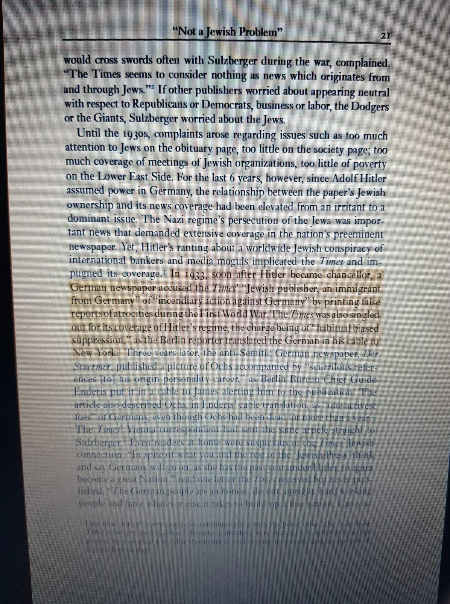 The image is a photograph of a book page titled "Not a Jewish Problem," focusing on historical coverage and critique involving The New York Times, specifically regarding its Jewish ownership and coverage of Jewish issues during the 1930s and World War II. The text discusses how The Times was critiqued for its coverage of Jewish topics, with complaints about the extent of attention given to Jews on various sections like obituaries and society pages. It also highlights the tensions following Adolf Hitler's rise to power, noting accusations from a German newspaper against The Times for alleged biased reporting against Germany. This accusation was linked to the Jewish ownership of the paper and its coverage of Nazi regime activities. The format is a black-and-white printed page with clear text aligned neatly, indicative of a scholarly or historical book. The text is dense and informative, set within a typical book layout, with the page number "21" visible in the top corner.