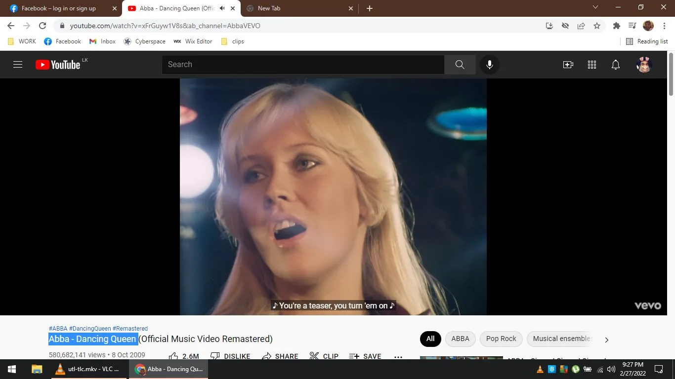 The screenshot captures a moment from the music video "Abba - Dancing Queen (Official Music Video Remastered)" on YouTube. The focal point of the image is Agneta Åse "Agnetha" Fältskog, who is prominently featured singing. She has blonde hair and is captured in a close-up shot with a soft, ambient light highlighting her features, which creates a warm, inviting atmosphere. The background is slightly blurred, focusing the viewer’s attention on her expressive performance. The lighting is reminiscent of a stage setting, with soft glows and gentle flares that enhance the mood of the song.
The video is published on the AbbaVEVO channel, and this particular frame includes subtitles at the bottom that read, "You're a teaser, you turn 'em on," complementing the lyrics being sung. The interface shows typical YouTube elements, including the view count and interaction buttons below the video. The visual style is classic and polished, reflecting the remastered nature of the video, with vibrant colors and clarity that bring a fresh feeling to the nostalgic hit. The scene is designed to evoke the charm and charisma characteristic of ABBA's performances.