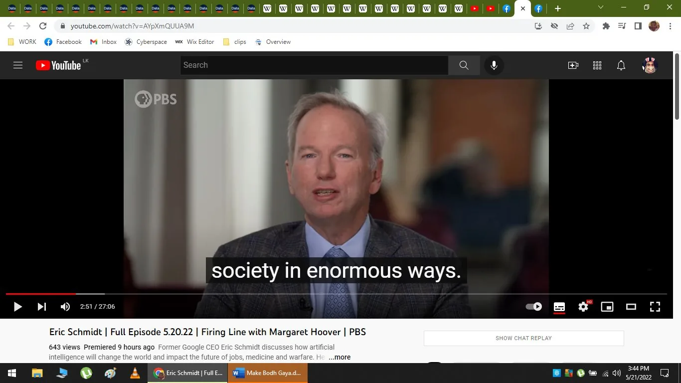 The image is a video frame from YouTube featuring Eric Schmidt in an interview setting. The title of the video is "Eric Schmidt | Full Episode 5.20.22 | Firing Line with Margaret Hoover | PBS," available on the PBS channel. The frame shows Eric Schmidt, who appears to be speaking during an interview on the show "Firing Line with Margaret Hoover." The production is by PBS, and it discusses societal impacts, possibly involving technology, as indicated by the subtitle "society in enormous ways."
Eric Schmidt is dressed formally in a suit with a light blue shirt and tie, sitting in what appears to be an indoor setting with blurred elements in the background, suggesting a professional or studio environment. The lighting is bright and focused on Schmidt, highlighting his expressions as he speaks. The video is recent, as it premiered 9 hours ago, according to the view count and timestamp at the bottom of the frame. The interface includes typical YouTube elements such as play controls, a progress bar, and video quality settings.