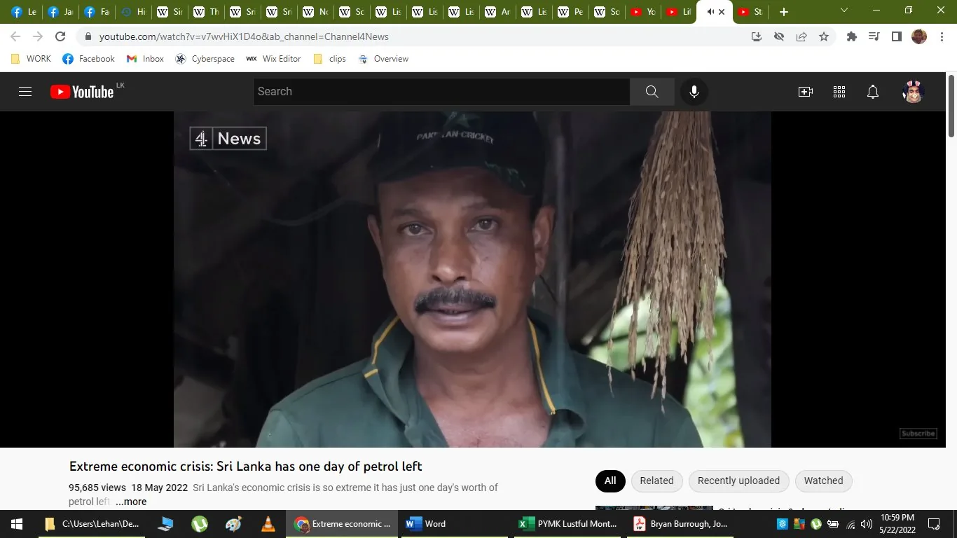 The screenshot is from a YouTube video titled "Extreme economic crisis: Sri Lanka has one day of petrol left," uploaded by Channel 4 News. The image features a man in a green uniform with a cap that appears to have text on it, standing outdoors in a natural setting. The background is somewhat blurred, with what looks like a thatched roof behind him, suggesting a rural or rustic environment. The lighting is natural, indicating it was likely filmed during the day. The man seems to be in the middle of an interview or speaking to the camera, as the expression on his face is serious and focused. This visual is part of a news report discussing the severe economic situation in Sri Lanka, specifically highlighting the critical shortage of petrol. The upper left corner of the image displays the Channel 4 News logo. The YouTube interface is visible, showing various icons and tabs at the top of the screen, along with a video description at the bottom that mentions the crisis.