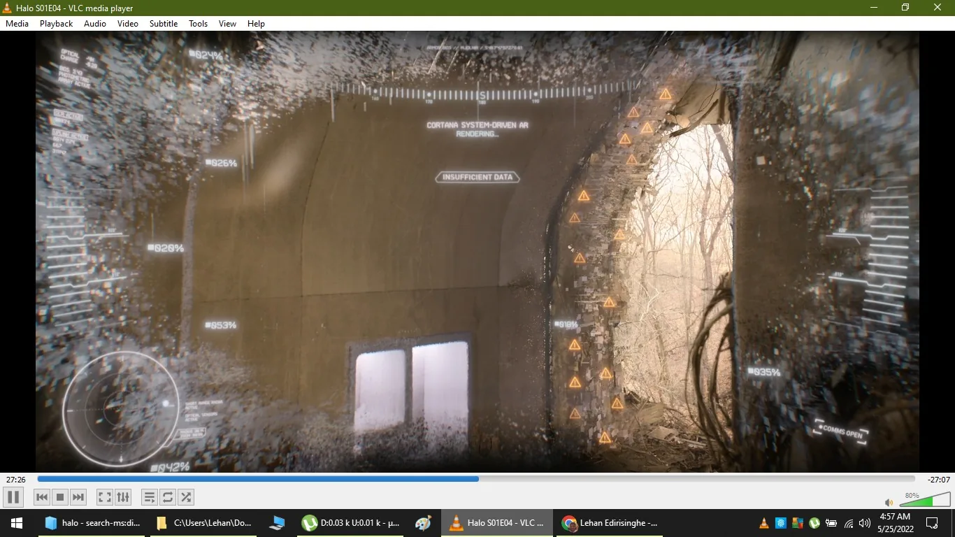```
The image is a screenshot from an episode of "Halo," specifically Season 1, Episode 4, viewed on VLC media player. The scene features a digital, augmented reality interface, likely part of a Cortana system from the "Halo" universe. The setting is a dimly lit, tunnel-like structure with a large, arched opening to the outside, showing bare trees, suggesting an outdoor or forested area in the background.
The foreground is dominated by a high-tech digital overlay displaying various data and alerts. Among the prominent on-screen texts are "CORTANA SYSTEM-DRIVEN AR RENDERING..." and "INSUFFICIENT DATA." Various percentage indicators and warning symbols line the right side of the screen, suggesting a scan or analysis of the surroundings. The interface uses a holographic effect, with elements like circular graphs and percentage read-outs indicating a futuristic and data-driven analysis.
The lighting is subdued and somewhat muted, enhancing the sci-fi ambiance. The digital overlay features a mix of white and orange elements, highlighting different types of information and alerts. The scene reflects the high-tech, strategic elements typical of the "Halo" universe, with advanced technology integrated into the narrative to provide insights or strategic advantages to characters within the story.