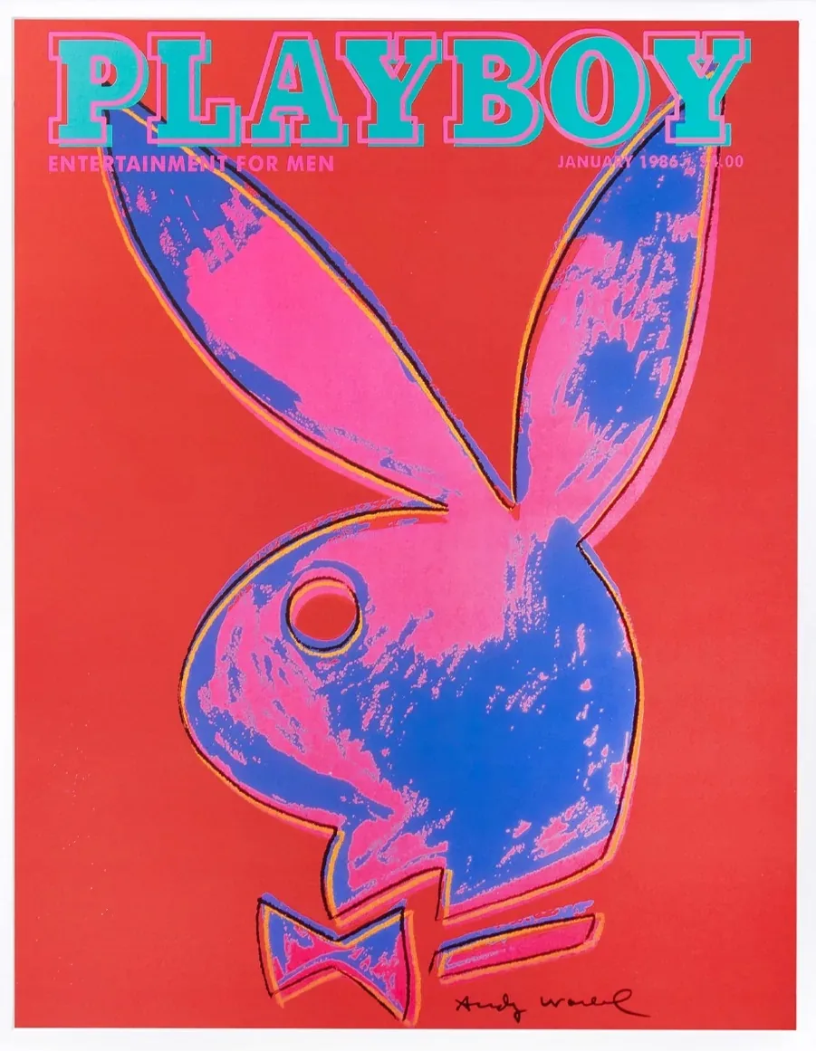 This image is a cover of the Playboy magazine, designed in a pop art style by Andy Warhol. The background is a bold red, and the iconic Playboy bunny logo is featured prominently in the center. The bunny is stylized with vibrant colors—pink and blue—with orange outlines creating a striking contrast. The logo appears as if painted with broad brushstrokes, typical of Warhol's distinctive style. The word "PLAYBOY" is printed at the top in large turquoise letters, highlighted with pink to stand out against the red background. Below, it states “ENTERTAINMENT FOR MEN.” The issue date "JANUARY 1986" and the price "$4.00" are printed in the top right corner. Warhol's signature can be seen at the bottom right, adding to the artwork's authenticity and appeal. The overall composition is both dynamic and visually engaging, showcasing Warhol's influence and the magazine's iconic branding.