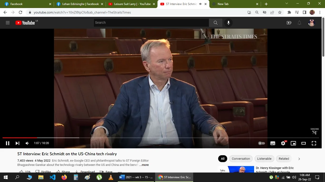 The image is a video frame from a YouTube interview titled "ST Interview: Eric Schmidt on the US-China tech rivalry," hosted on the channel TheStraitsTimes. The visual captures Eric Schmidt, who is recognized based on the hint, sitting inside a spacious, wood-paneled room that resembles a legislative or academic setting. Eric Schmidt is dressed in a blue blazer over a white shirt, seated in a leather chair. His posture is attentive, and he seems engaged in the conversation. The lighting in the room is warm, highlighting the polished wooden details in the background. The video is presented by The Straits Times, and the subject matter focuses on technology and geopolitical relations between the US and China. No captions or subtitles are visible in this particular frame.
- Title: "ST Interview: Eric Schmidt on the US-China tech rivalry"
- Channel / profile: "TheStraitsTimes"
- Site / app: "YouTube"