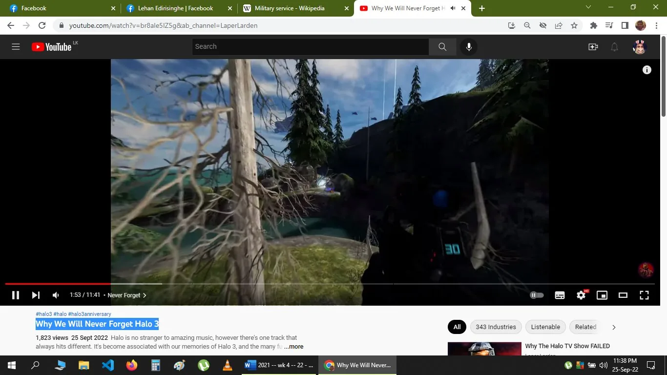 The screenshot captures a YouTube video titled "Why We Will Never Forget Halo 3" from the channel LaperLarden. The video, which has 1,823 views as of September 25, 2022, is a tribute to the game "Halo 3." The content is visually centered around a first-person perspective from within a game environment, showing a rugged landscape with trees and a body of water. A weapon with a digital display indicating the number 30 is visible in the foreground, hinting at the video being focused on gameplay elements. The lighting is natural, suggesting daytime within the game. The tags associated with the video link it to the Halo series and its anniversary, indicating a nostalgic or commemorative theme. The caption "Never Forget" appearing on the screen suggests a focus on memorable aspects of the game.
- Title: "Why We Will Never Forget Halo 3"
- Channel / profile: "LaperLarden"
- Site / app: "YouTube"
- Captions / subtitles: "Never Forget"