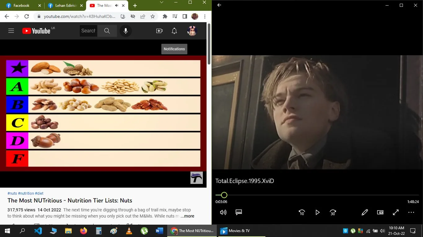The image is a split-screen screenshot. On the left side, there's a YouTube video titled "The Most NUTritious - Nutrition Tier Lists: Nuts." The video thumbnail shows a tier list with various nuts categorized from a star tier down to an F tier. The nuts are visually arranged with images of almonds, walnuts, cashews, and others placed in designated tiers, indicating a ranking based on nutritional value or preference. The video's views and upload date are also visible, showing it has 317,975 views and was uploaded on October 14, 2022. The YouTube interface includes typical elements like navigation bars and a profile icon.
On the right side, there is a scene from the movie "Total Eclipse," showing a young individual gazing intently with a serious expression. The scene is likely set outdoors, as suggested by the lighting and background. The video player interface is visible, displaying a timestamp at 3:06 and a total length of 1:48:24. The contrasting themes of the nutritional tier list and a dramatic film moment create an interesting juxtaposition. The user seems to be multitasking between browsing nutritional content and watching a historical drama film.