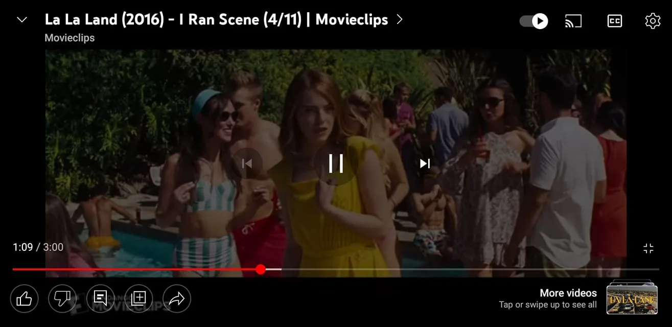 The screenshot displays a scene from the movie "La La Land," featuring Emma Stone. She is in the foreground wearing a bright yellow dress, appearing to be at a pool party. Her expression is focused and thoughtful as she navigates through the crowd. The background is lively, with several people enjoying the pool and socializing. A woman in a striped swimsuit and sunglasses is seen smiling, interacting closely with another party-goer. The atmosphere is vibrant, suggesting a sunny day with plenty of activity and conversation. The colors are bright, with a mix of summery outfits and lush greenery. The scene captures a quintessentially Californian vibe, fitting the film’s setting and mood. The interface shows controls for video playback, indicating that this is a video clip from Movieclips, specifically highlighting a scene titled "I Ran Scene (4/11)" from "La La Land."