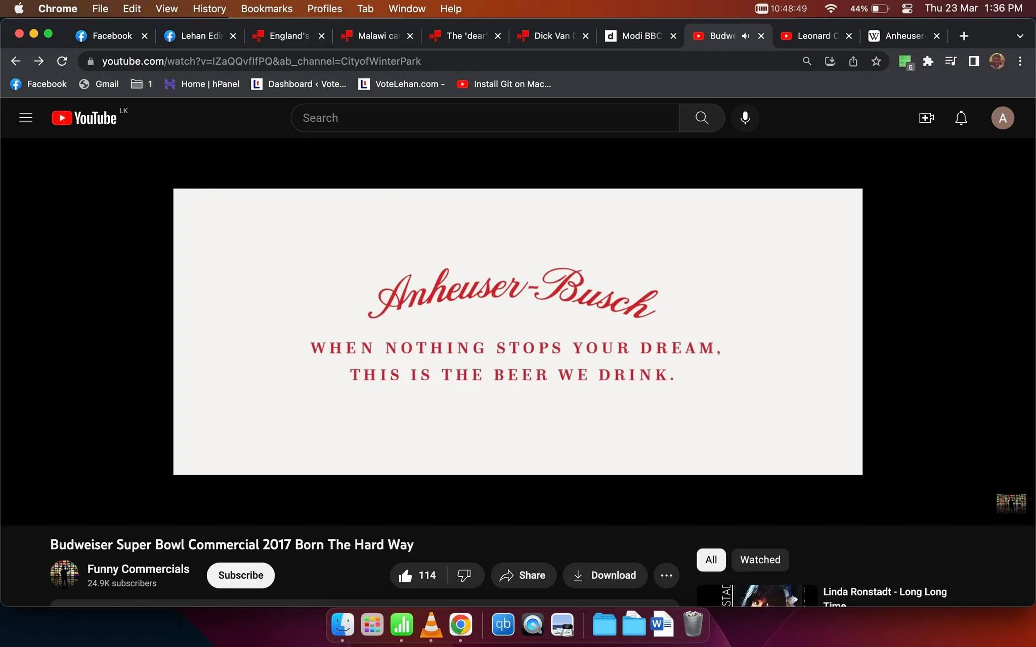 The screenshot is from a YouTube video titled "Budweiser Super Bowl Commercial 2017 Born The Hard Way," hosted on the channel "Funny Commercials." The main focus of the image is a promotional message from Anheuser-Busch, displayed prominently in the center. The text reads: "Anheuser-Busch" in a stylish, red script font, followed by "WHEN NOTHING STOPS YOUR DREAM, THIS IS THE BEER WE DRINK." in a bold, red uppercase font. This text is set against a plain white background, enhancing its visibility and impact.
The web browser tabs visible at the top of the screen indicate that the user is viewing this on a computer, likely a MacBook given the macOS interface elements, such as the menu bar at the top and the dock at the bottom, which includes application icons like Finder, Safari, and Mail. The YouTube interface shows options for subscribing, liking, sharing, and downloading the video, with the "Like" count at 114. The video appears to be related to the 2017 Super Bowl, specifically promoting Budweiser, a product of Anheuser-Busch. The overall tone of the image conveys a sense of aspiration and determination, in line with the promotional slogan presented.