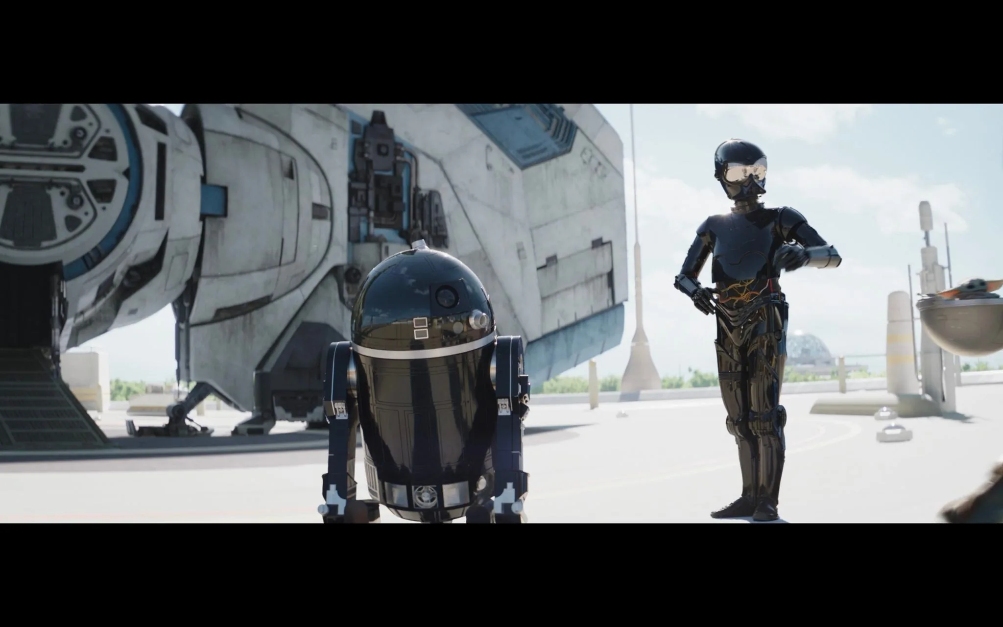 A scene from the "Star Wars" universe features two droids and part of a spaceship. In the foreground, an astromech droid, reminiscent of the iconic R2-D2 but in a sleek black color, stands on the left. Its dome-shaped head and cylindrical body reflect the bright sunlight. To the right, a humanoid protocol droid, also in a shiny black finish, stands with one arm bent and resting on its hip, suggesting an air of attentiveness or readiness. The reflective surfaces of both droids emphasize the high-tech, futuristic setting.
In the background, a large spaceship with a rugged, well-used appearance is visible. Its design is characteristic of the "Star Wars" aesthetic, with visible panels and industrial detailing. The scene is set outdoors, under a clear blue sky, with tall spires visible in the distance, hinting at a spaceport or futuristic cityscape. The lighting is bright, casting clear shadows on the ground, enhancing the scene's sense of realism.
- Title: "..."
- Channel / profile: "..."
- Site / app: "..."
- Captions / subtitles: "..."