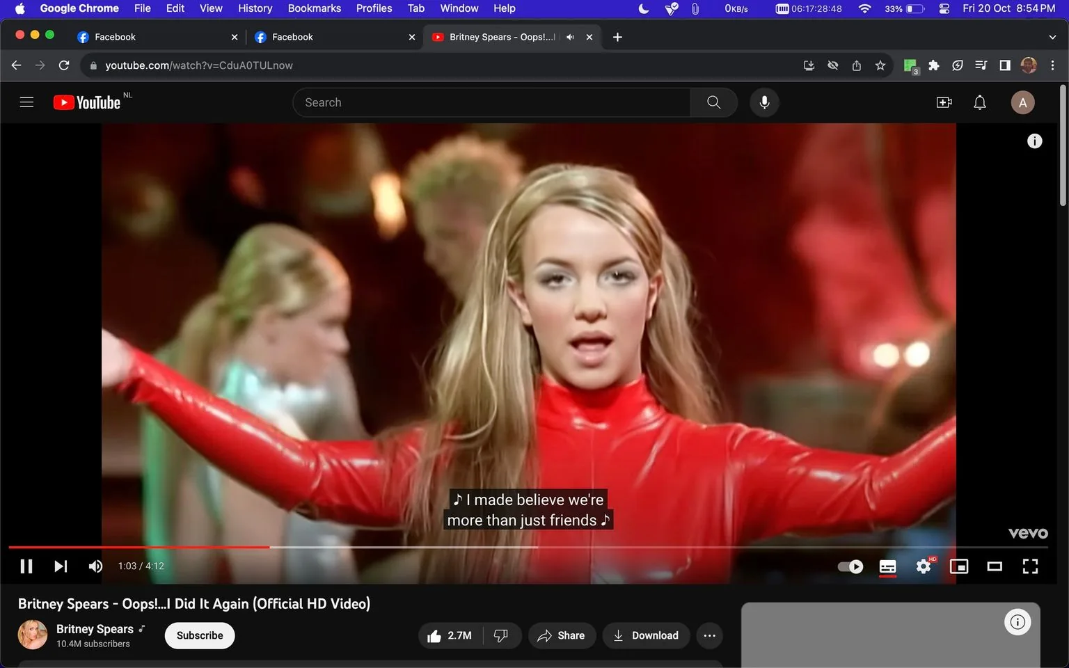 Britney Spears is featured in this screenshot from her music video "Oops!...I Did It Again," available on YouTube. She is seen in the foreground wearing an iconic red latex bodysuit with her arms outstretched. Her long blonde hair is styled straight, resting over her shoulders, and she appears to be singing with a confident expression. The background includes two dancers dressed in silver outfits, slightly out of focus, enhancing the dynamic choreography typical of her performances. The lighting is warm, with red and orange tones dominating the scene, creating a vibrant and energetic atmosphere. The video is hosted on Britney Spear's official YouTube channel, which has a large following, as indicated by the 10.4M subscribers. Captions at the bottom of the screen display the lyrics, adding to the engaging visual and auditory experience for viewers.
- Title: "Britney Spears - Oops!...I Did It Again (Official HD Video)"
- Channel / profile: "Britney Spears"
- Site / app: "YouTube"
- Captions / subtitles: "I made believe we're more than just friends"
