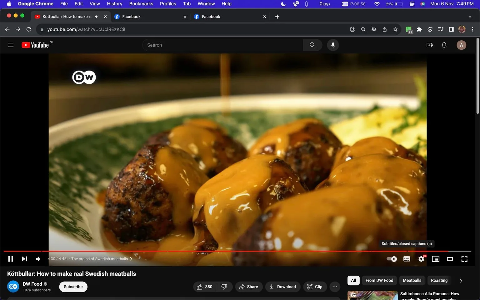 The image is a video frame from YouTube showing a close-up of Swedish meatballs covered in rich, golden-brown gravy. The meatballs are plated on a green and white patterned dish, suggesting a traditional or rustic presentation. The lighting highlights the glossy texture of the sauce, making the dish appear appetizing and freshly prepared. In the background, there appears to be a side of mashed potatoes, garnished with herbs, complementing the meatballs. The video is titled "Köttbullar: How to make real Swedish meatballs" and is from the channel DW Food, which has 107K subscribers. The interface shows typical YouTube elements such as the like, share, and download buttons, along with playback controls, indicating that the video is near the end with a timestamp of 4:30 out of 4:45. The video appears to be part of a cooking segment focused on authentic Swedish cuisine, emphasizing traditional methods and ingredients.