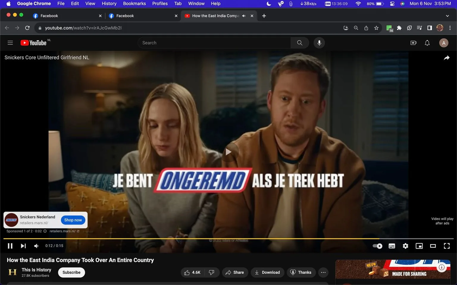 The screenshot captures a YouTube video page featuring a Snickers advertisement titled "Snickers Core Unfiltered Girlfriend NL." The scene shows a man and a woman sitting closely on a couch in a warmly lit living room. The woman, with long blonde hair, is looking down with a neutral expression, while the man appears to be speaking or reacting to something off-screen.
The text overlay in Dutch reads "Je bent ongeremd als je trek hebt," which translates to "You are unrestrained when you are hungry." This aligns with Snickers' well-known advertising slogan. Below the main text, there's a call-to-action to visit "retailers.mars.nl," indicating the commercial's connection to the Mars company, which owns Snickers.
The YouTube interface shows the video title "How the East India Company Took Over An Entire Country," attributed to the channel "This Is History," a part of the History network. This suggests that the main content will resume after the ad. The video's control panel at the bottom displays typical features like play/pause, volume, and progress bar, with a small advertisement banner for Snickers Nederland. The setting is cozy, with soft lighting and a muted color palette, complementing the intimate and conversational tone of the scene.