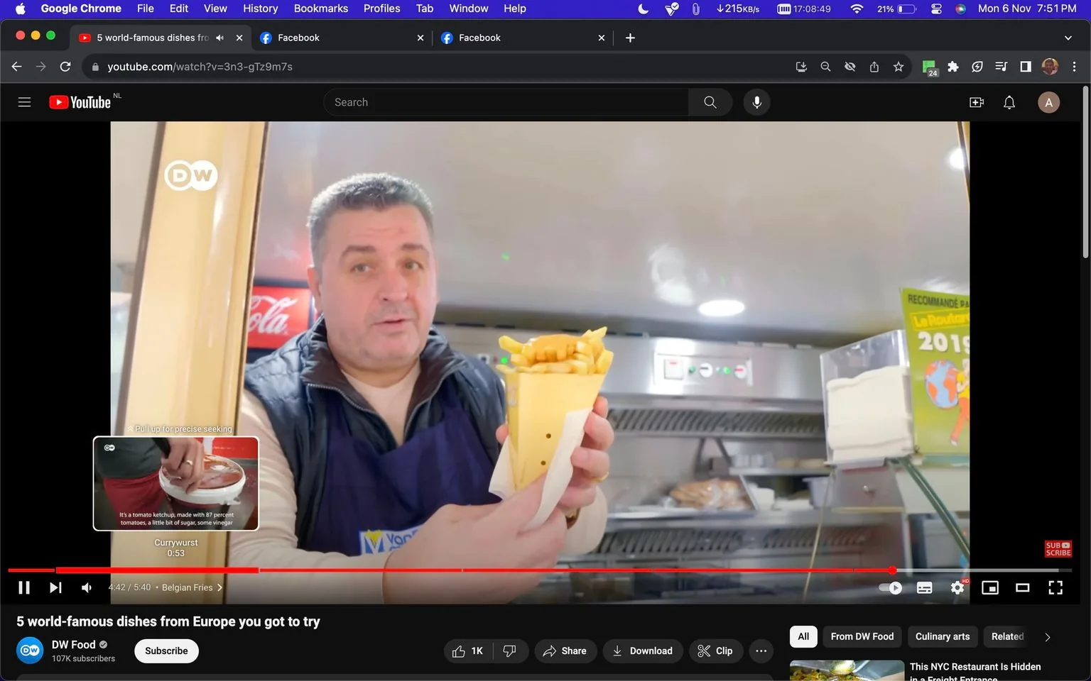 A man is visible inside a food stall or kitchen setting, holding a cone filled with Belgian fries. He appears to be explaining something related to the dish. The setting seems clean and brightly lit, enhancing the focus on the food item he holds. Behind him, a Coca-Cola fridge is partially visible, adding a recognizable brand element to the scene. There’s also a sign on the wall that reads "RECOMMANDE PAR La Routard 2019," suggesting a recommendation or endorsement from a travel guide.
He wears a dark apron over a light-colored shirt, indicating his role in food preparation or service. His expression is professional yet approachable, suggesting he is engaged in explaining or presenting the fries. The video appears to be part of a series or segment titled "5 world-famous dishes from Europe you got to try" by DW Food, which is the YouTube channel hosting the video. The screenshot also shows video playback controls, indicating it's a paused frame from a video.
- Title: "5 world-famous dishes from Europe you got to try"
- Channel / profile: "DW Food"
- Site / app: "YouTube"
- Captions / subtitles: "It's a tomato ketchup, made with 87 percent tomatoes, a little bit of sugar, some vinegar"