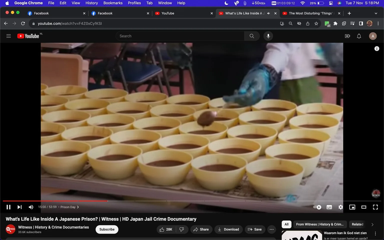 The image shows a scene from a YouTube video titled "What's Life Like Inside A Japanese Prison? | Witness | HD Japan Jail Crime Documentary," uploaded by the channel "Witness | History & Crime Documentaries." The frame captures a kitchen setting where numerous yellow bowls containing a brown liquid, possibly soup or broth, are neatly arranged on a table. A person wearing a white uniform and blue gloves is in the process of preparing or serving the food, using a spoon to distribute the contents evenly into the bowls. The environment appears organized and clean, typical of institutional food preparation areas. The background includes additional tables, chairs, and possibly other kitchen equipment, indicating it is part of a larger dining or kitchen facility within a prison. The lighting is bright, suggesting the scene is shot during the day. The video explores prison life, focusing on daily routines and environments within a Japanese prison.