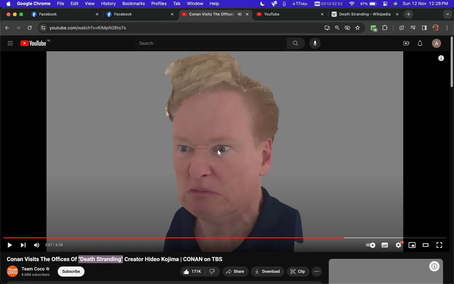 The image is a screenshot from a YouTube video titled "Conan Visits The Offices Of 'Death Stranding' Creator Hideo Kojima | CONAN on TBS," available on the Team Coco channel. The scene features a digital rendering of Conan O'Brien. The rendering captures a close-up of his face with an exaggerated and humorous expression, characterized by a furrowed brow and pursed lips, suggesting a dramatic or playful mood. The background is a plain gray, emphasizing the character's features. This rendering may be an in-game model or a stylized version of Conan, given the context of his visit to the offices of Hideo Kojima, the creator of the game "Death Stranding." The top of the screen shows multiple browser tabs open, indicating multitasking or research, while the bottom displays video engagement metrics such as likes and subscribers, highlighting audience interaction. The composition is focused on humor and novelty, typical of Conan's comedic style.