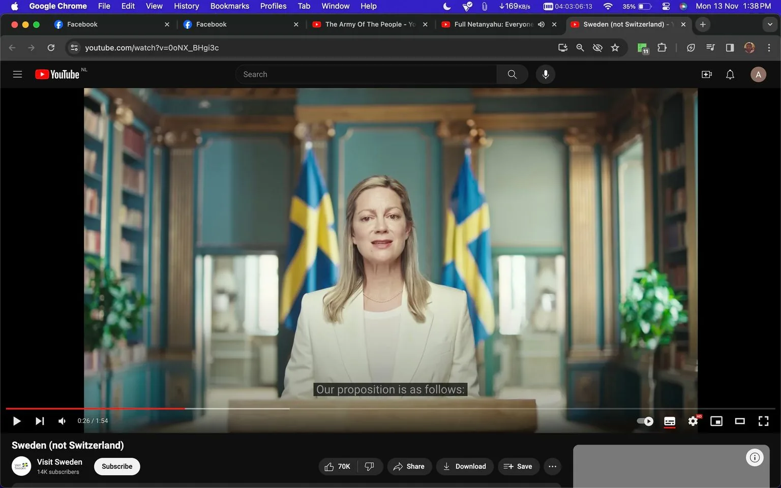 The image is a screenshot from a YouTube video titled "Sweden (not Switzerland)" on the channel "Visit Sweden." The scene is set indoors with a woman standing at a podium, delivering a speech. She is wearing a white suit, exuding a professional and formal appearance. Behind her are two Swedish flags, emphasizing the official and national context of the setting. The background includes decorative columns and bookshelves, suggesting an elegant or official government space. The lighting is bright and focused, accentuating her presence as she addresses the audience.
The on-screen text includes the YouTube URL "youtube.com/watch?v=0oNX_BHgi3c" and subtitles displaying the line "Our proposition is as follows:". The scene captures a moment of an official speech or announcement, with the woman maintaining a composed and attentive expression. The video likely relates to promoting Swedish culture or tourism, as indicated by the channel's name.