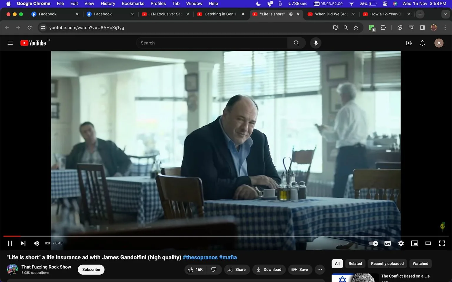 James Gandolfini is seated at a table in a restaurant setting for a life insurance ad. The scene is indoors with natural light streaming in through large windows, creating a soft ambiance. James Gandolfini is wearing a dark jacket over a light blue shirt, and he has a thoughtful expression, perhaps suggesting reflective or serious themes typical of a life insurance advertisement. The table has a checkered tablecloth, and there are various condiments placed on it, contributing to the casual dining atmosphere. In the background, other patrons and a server can be seen, adding a sense of normalcy and everyday life to the scene. The colors are muted, enhancing the reflective mood of the ad. The video is a high-quality production with clear emphasis on Gandolfini, suggesting his importance in the ad's messaging.
- Title: "\"Life is short\" a life insurance ad with James Gandolfini (high quality) #thesopranos #mafia"
- Channel / profile: "That Fuzzing Rock Show"
- Site / app: "YouTube"