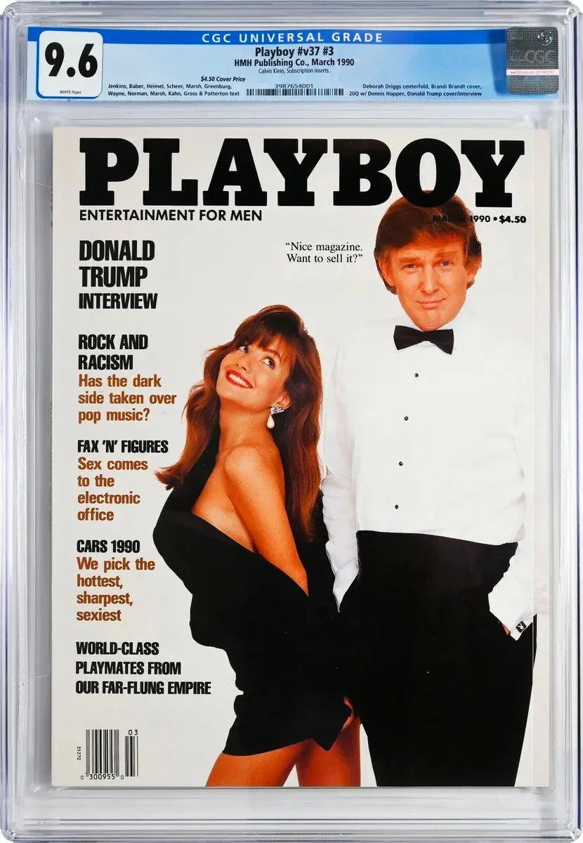 ```
The image shows a magazine cover of Playboy from March 1990, prominently featuring President Trump alongside a woman in formal attire. President Trump is dressed in a white tuxedo shirt with a black bow tie, exuding a formal and confident demeanor. The woman beside him is wearing a black, off-shoulder dress, smiling brightly, adding a glamorous touch to the scene. The cover is encased in a CGC Universal Grade slab, rated 9.6, indicating its high condition quality.
The title "PLAYBOY" is boldly printed at the top, followed by the subtitle "ENTERTAINMENT FOR MEN." Several feature articles are listed on the left side, including "DONALD TRUMP INTERVIEW," "ROCK AND RACISM," "FAX 'N' FIGURES," and "CARS 1990." A quote attributed to President Trump, "Nice magazine. Want to sell it?" is showcased beside him, hinting at his business acumen. The magazine is published by HMH Publishing Co., and the cover price is noted as $4.50. The overall composition is sharp and polished, with a clean, professional look characteristic of a high-profile magazine cover.