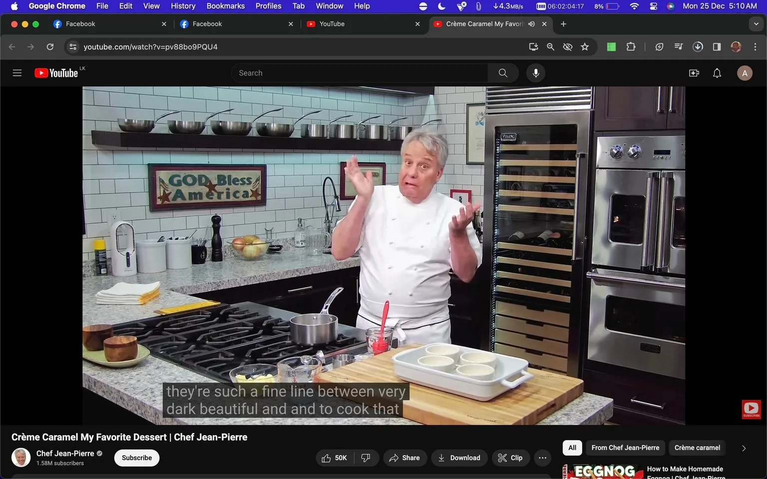 The image is a screenshot from a YouTube video titled "Crème Caramel My Favorite Dessert | Chef Jean-Pierre." It features Chef Jean-Pierre standing in a modern kitchen setting, likely hosting a cooking show. The kitchen has a sleek and organized design, with a countertop filled with various ingredients and cooking utensils. There are ramekins placed on a cutting board, suggesting a dessert preparation, specifically crème caramel, as indicated in the title. Chef Jean-Pierre is wearing a traditional white chef's coat and is gesturing with his hands, appearing to explain or emphasize a point in his recipe. The background includes stainless steel appliances, such as a wine cooler and an oven, and a sign that reads "GOD Bless America." The lighting is bright, highlighting the clean and professional kitchen environment. Subtitles on the screen read "they're such a fine line between very dark beautiful and and to cook that," suggesting a discussion about cooking techniques or nuances.
- Title: "Crème Caramel My Favorite Dessert | Chef Jean-Pierre"
- Channel / profile: "Chef Jean-Pierre"
- Site / app: "YouTube"
- Captions / subtitles: "they're such a fine line between very dark beautiful and and to cook that"