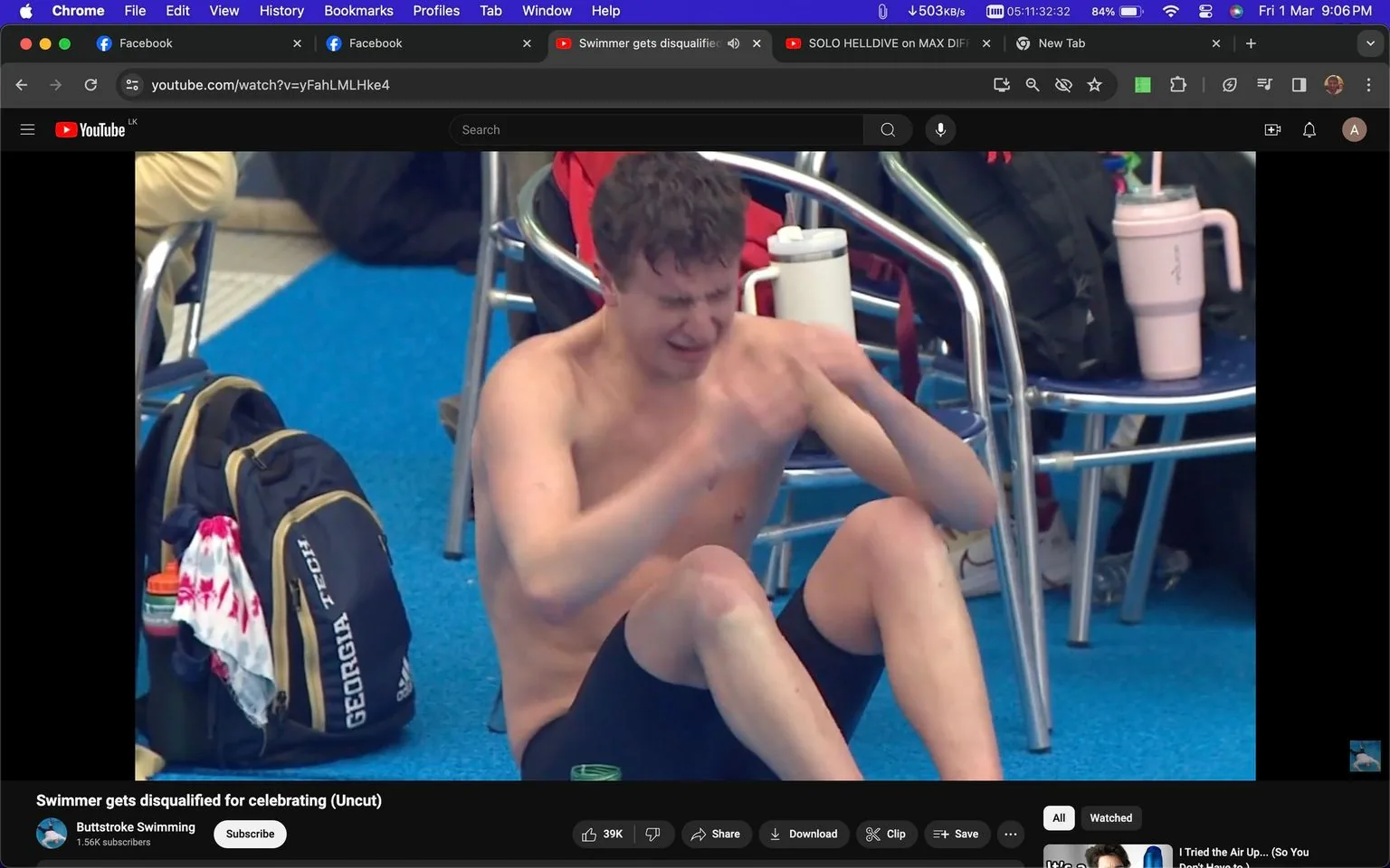 The image is a screenshot from a YouTube video titled "Swimmer gets disqualified for celebrating (Uncut)" on the channel "Buttstroke Swimming." The scene appears to be set indoors at a swimming event, with a blue floor and several chairs visible in the background. In the foreground, a swimmer, shirtless and wearing black swim shorts, sits on the ground with an emotional expression, possibly indicating distress or disappointment. Nearby, there are personal items like backpacks, one of which has "GEORGIA TECH" printed on it, suggesting a collegiate connection. The video seems to capture a moment of intensity and emotion, likely related to the swimmer's disqualification. The overall mood is somber, reflecting the challenging circumstances faced by the athlete.
- Title: "Swimmer gets disqualified for celebrating (Uncut)"
- Channel / profile: "Buttstroke Swimming"
- Site / app: "YouTube"