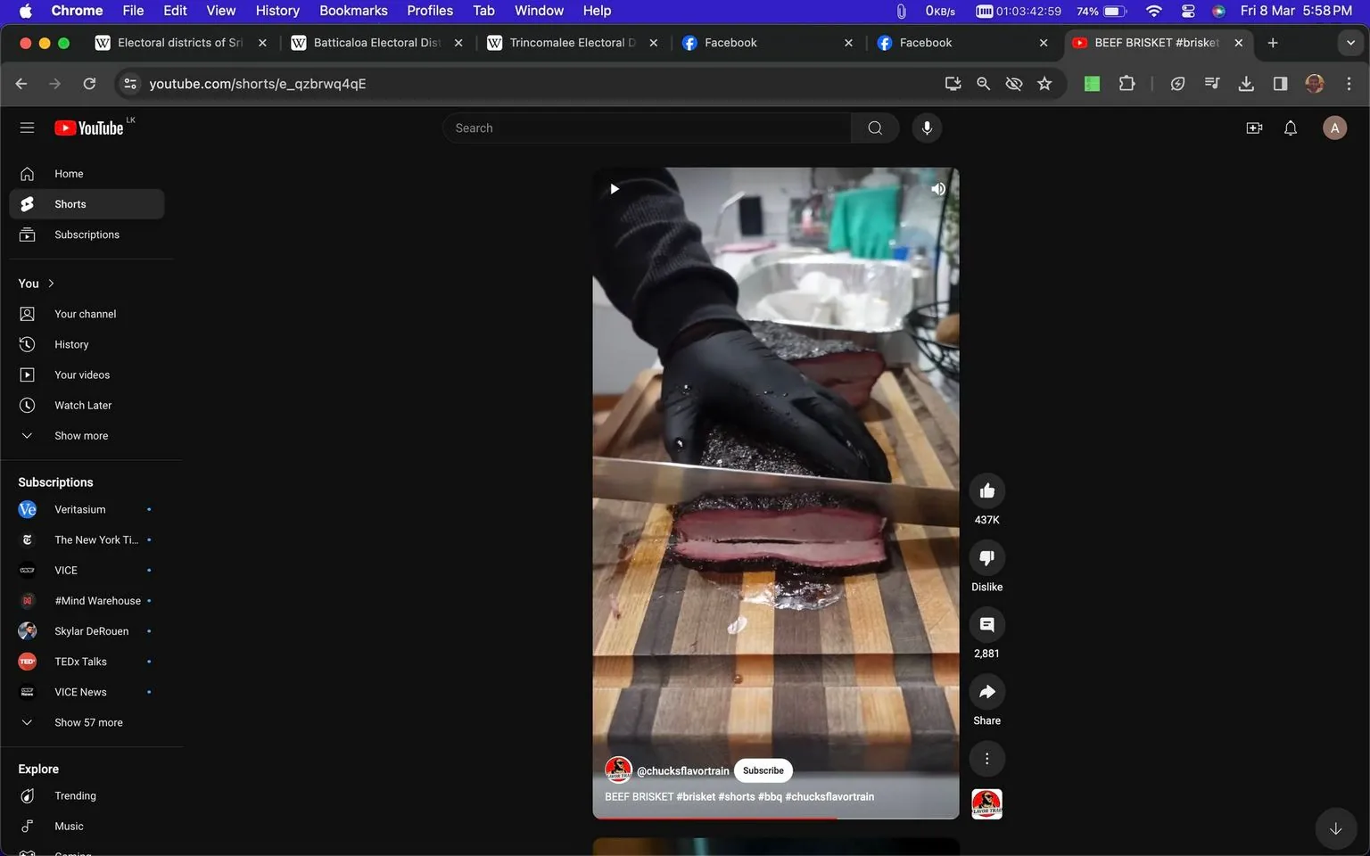 The screenshot shows a YouTube Shorts video from the channel @chucksflavortrain. In the video, a person is cutting into a piece of beef brisket with a large knife on a wooden cutting board. The person is wearing a black glove on one hand, which is holding the brisket steady while slicing. The brisket has a dark, seasoned crust on the outside and reveals a pink, juicy interior. The setting appears to be a kitchen, with various kitchen items like foil trays and a towel visible in the background. The image conveys a sense of culinary expertise and delicious barbecue preparation. The lighting is bright, highlighting the texture and color of the brisket, making it visually appealing and appetizing.
