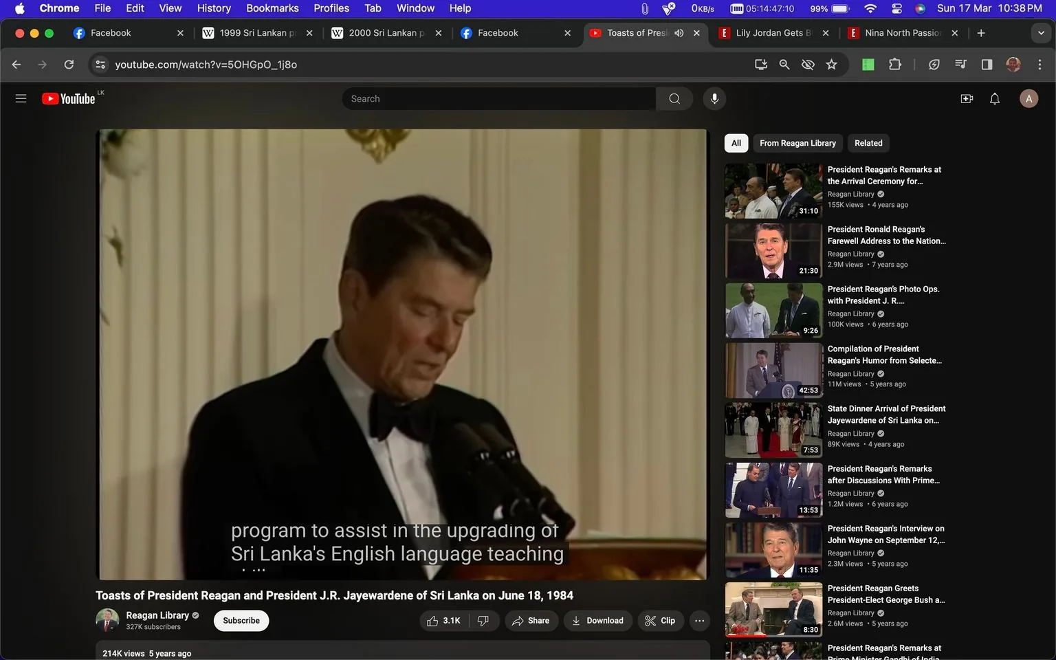 Ronald Reagan is depicted in a formal setting, delivering a speech. He is dressed in a classic black tuxedo with a bow tie, standing behind a microphone against an elegant backdrop, likely in a formal venue or a government building. The lighting is warm, highlighting Reagan as he speaks. The video is from a YouTube channel called "Reagan Library," with the title indicating it features toasts by Ronald Reagan and President J.R. Jayewardene of Sri Lanka on June 18, 1984. The on-screen caption reads, "program to assist in the upgrading of Sri Lanka's English language teaching," suggesting a diplomatic or cooperative educational initiative. The video sidebar shows related content about Ronald Reagan, confirming the historical and political context of the image. The screenshot captures a moment from a significant diplomatic exchange, reflecting the formal and serious tone of the event.
- Title: "Toasts of President Reagan and President J.R. Jayewardene of Sri Lanka on June 18, 1984"
- Channel / profile: "Reagan Library"
- Site / app: "YouTube"
- Captions / subtitles: "program to assist in the upgrading of Sri Lanka's English language teaching"