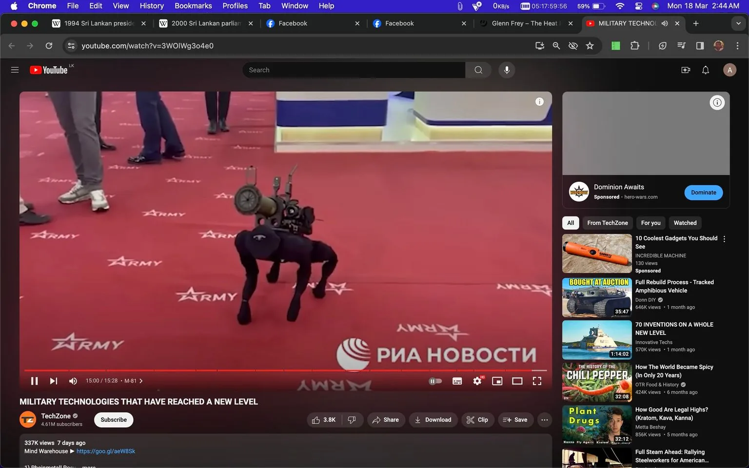 The screenshot is taken from a YouTube video titled "MILITARY TECHNOLOGIES THAT HAVE REACHED A NEW LEVEL," featured on the channel TechZone. It shows a demonstration of advanced military technology. The center of the image features a robotic dog equipped with what appears to be a mounted weapon or equipment on its back, suggesting its role in military applications. The robot is positioned on a red carpet adorned with the text "ARMY," indicating a formal or exhibition setting. The carpeted area is indoors, and people are visible in the background, wearing casual attire, such as jeans and sneakers, observing the demonstration.
In the lower-right corner, the logo of "РИА НОВОСТИ" is prominently displayed, indicating the source of the content. The lighting is bright, typical of an indoor exhibition. The interface shows YouTube's layout with video details like views and upload time visible. Suggested videos are displayed on the right side, with topics related to technology and military innovations. The setting reflects a high-technology environment focusing on cutting-edge military advancements.