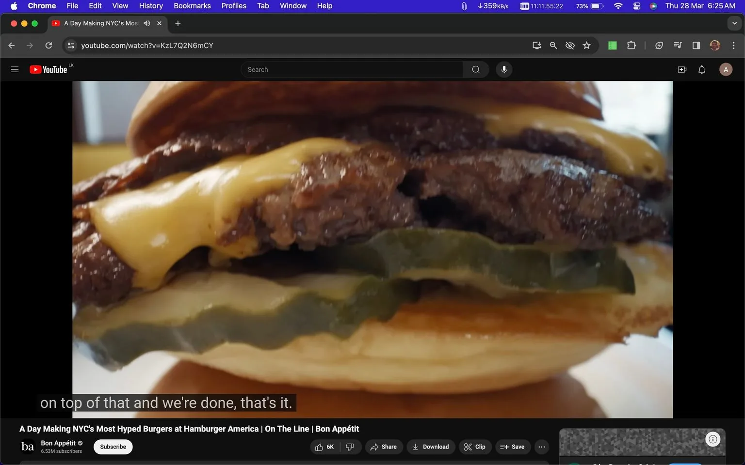 A close-up frame from a YouTube video on the Bon Appétit channel showcases a delicious-looking burger from Hamburger America, a location renowned for its popular burgers in NYC. The focus is on the burger, prominently displaying layers of juicy beef patties, melted cheese, and several pickle slices sandwiched between a soft bun. The cheese appears golden and perfectly melted over the sizzling beef, enhancing the appetizing presentation. The lighting brings out the textures and colors, making the burger appear fresh and savory. The video is titled "A Day Making NYC's Most Hyped Burgers at Hamburger America | On The Line | Bon Appétit," and the channel Bon Appétit is visible, emphasizing the culinary focus of the video. The subtitles read, "on top of that and we're done, that's it," suggesting the final steps in assembling the burger. The video is part of a feature that likely explores the making of these celebrated burgers in New York City.
- Title: "A Day Making NYC's Most Hyped Burgers at Hamburger America | On The Line | Bon Appétit"
- Channel / profile: "Bon Appétit"
- Site / app: "YouTube"
- Captions / subtitles: "on top of that and we're done, that's it."