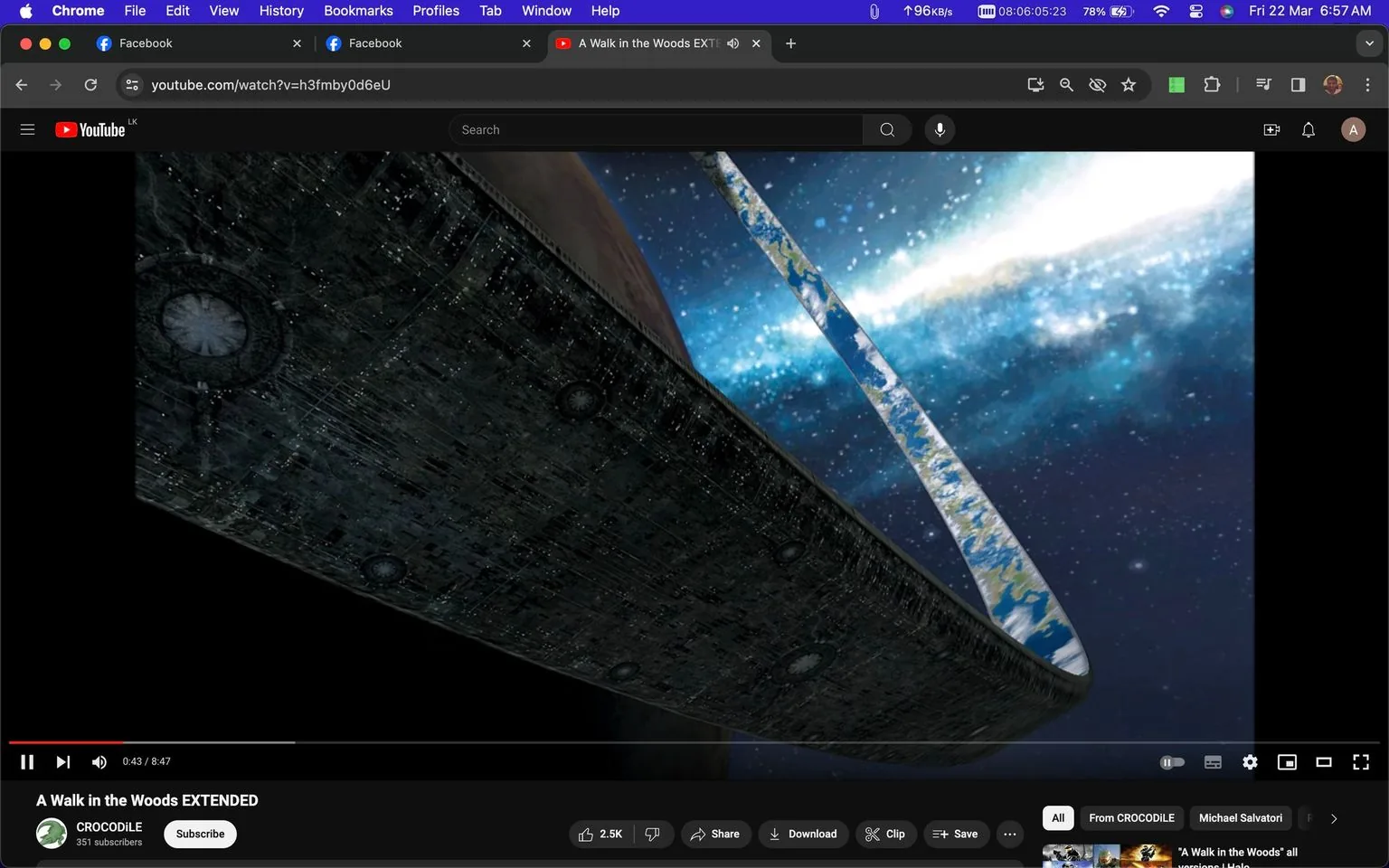 The screenshot captures a YouTube video titled "A Walk in the Woods EXTENDED" on the channel "CROCODiLE." The video is paused at 43 seconds into its 8-minute and 47-second duration. The scene depicted appears to be from a science fiction context, likely referencing the "Halo" universe, featuring a massive ring-like structure in space known as a "Halo ring." This structure partially wraps around a celestial body, visible amidst a backdrop of stars and cosmic dust. The ring shows detailed texture, resembling a complex, metallic surface, with patches of what appear to be land and water, suggesting an artificial habitat.
The interface of the YouTube page is visible, showing options like "Like," "Share," "Download," and "Clip" along the bottom. The video has garnered 2.5K likes. The browser interface indicates this is being viewed on Google Chrome, with additional tabs open, including Facebook. The overall mood is futuristic, with a color palette dominated by dark space tones contrasted with the bright, ethereal glow of the stars and the intricate details of the Halo structure.