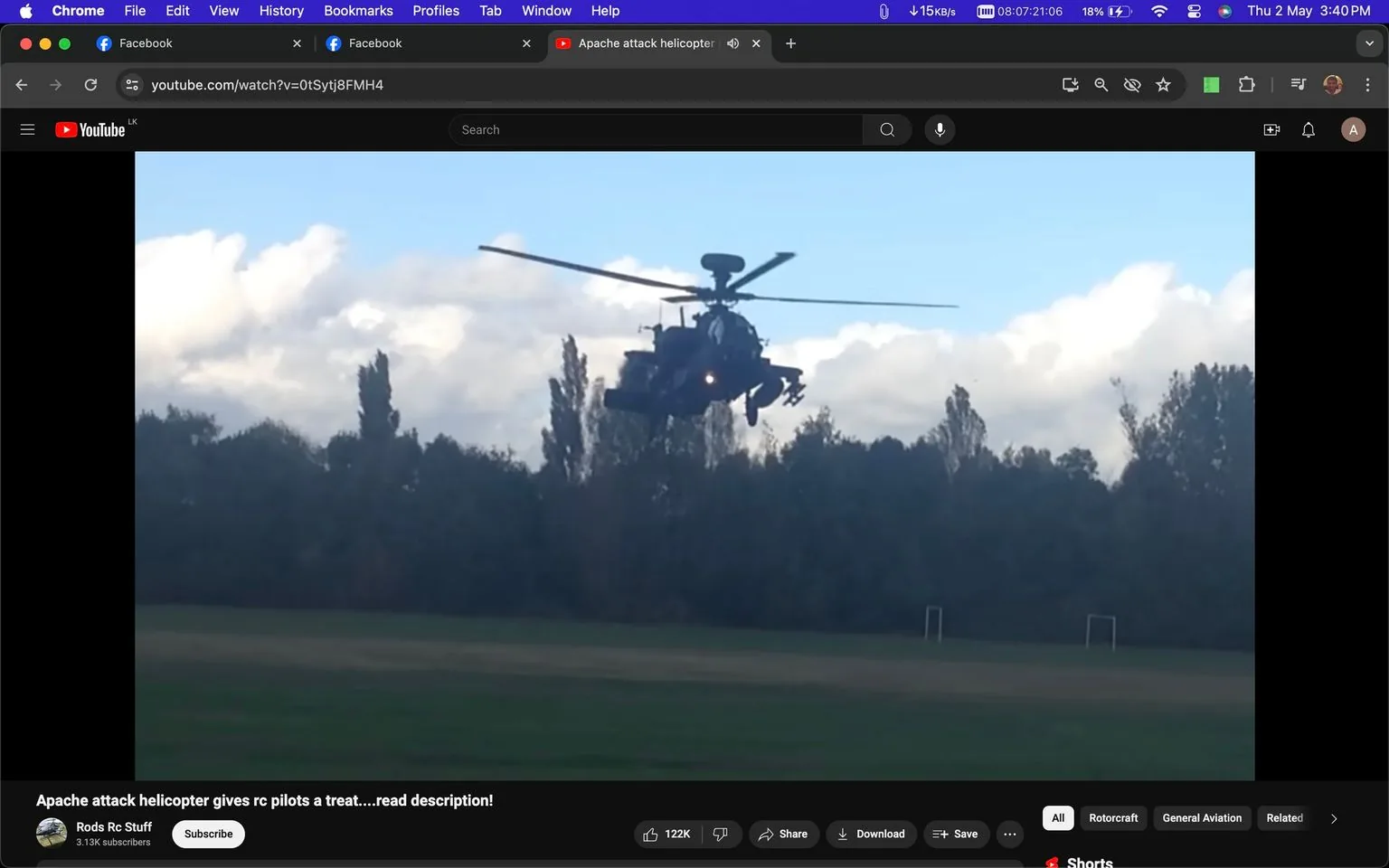 The image is a screenshot from a YouTube video on the channel "Rods Rc Stuff," showing an Apache AH-64 gunship helicopter in flight. The helicopter is captured in mid-air against a backdrop of trees and a partly cloudy sky, suggesting a daytime outdoor setting. The helicopter, known for its distinctive design, appears to be hovering above a grassy field, possibly indicating a demonstration or an event for RC pilots.
The screenshot includes the title "Apache attack helicopter gives rc pilots a treat....read description!" and shows the channel's subscriber count as 3.13K. Viewers have the options to like, share, download, or save the video, with 122K likes visible, indicating a high level of engagement. The interface suggests this is a web-based viewing session on a desktop, with browser tabs visible for other sites like Facebook.
- Title: "Apache attack helicopter gives rc pilots a treat....read description!"
- Channel / profile: "Rods Rc Stuff"
- Site / app: "YouTube"