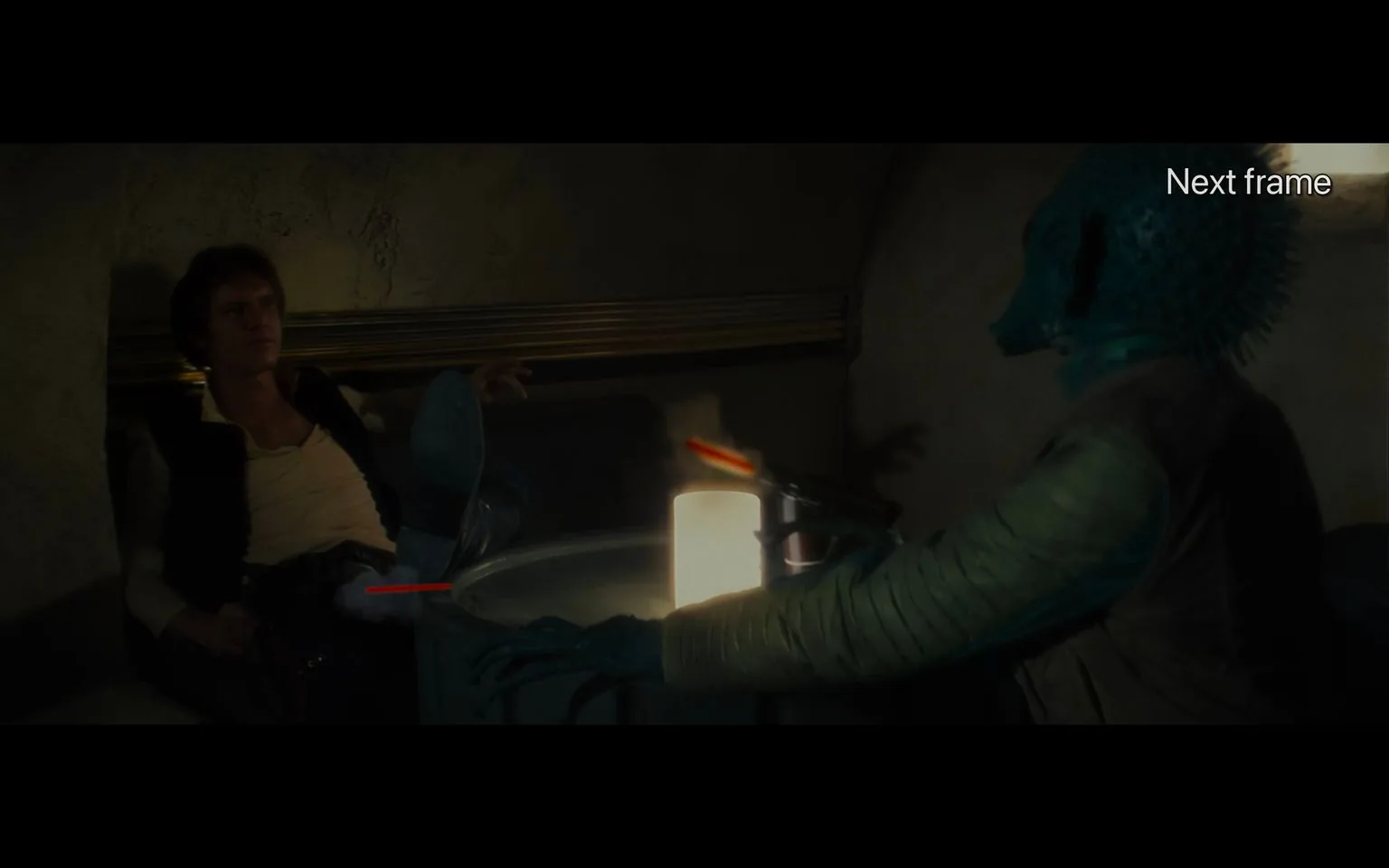 The image depicts a scene from "Star Wars," set in a dimly lit cantina. The atmosphere is tense, with two characters, one resembling a human and the other an alien, seated at a small table. The human character is lounging casually, with one leg propped up on the table, looking composed yet alert. He is dressed in a classic sci-fi style, with a vest over a light shirt and rugged pants and boots.
Across from him sits an alien with a reptilian appearance, characterized by its scaly skin and distinctive head shape. This character is aiming a blaster, and a red laser beam is visible, hinting at a moment of confrontation. The lighting is low, casting dramatic shadows and enhancing the suspense of the scene. A bright cylindrical light on the table provides the primary illumination, casting a glow on their faces and accentuating their expressions.
The setting is a small, enclosed booth with textured walls, typical of the cantina's gritty aesthetic. The composition emphasizes the standoff, with visual contrast between the characters’ postures and the tension of the moment. There are no subtitles or visible text apart from "Next frame," suggesting a frame from a video or film scene.