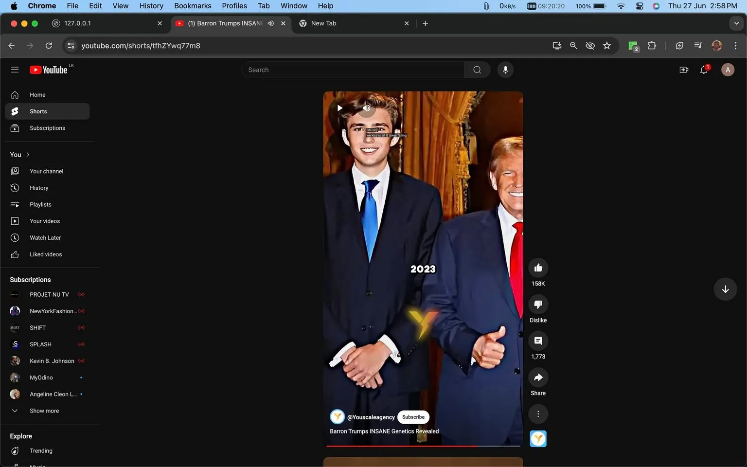 The image is a screenshot from a YouTube Shorts video titled "Barron Trumps INSANE Genetics Revealed," published by the channel @Youscaleagency. It shows a formal setting with two individuals in suits. The person on the left, identified by the context as Barron Trump, is wearing a dark suit with a white shirt and a blue tie. He stands with his hands clasped in front, displaying a composed demeanor. To his right is another person in a similar dark suit, white shirt, and red tie, giving a thumbs-up gesture. The background includes ornate curtains, suggesting a sophisticated or official setting. The text "2023" is superimposed near Barron Trump, indicating the year. The screenshot implies a focus on genetics and appearance, likely discussing physical attributes and family characteristics. The lighting is bright, highlighting the formal attire and expressions of the individuals.