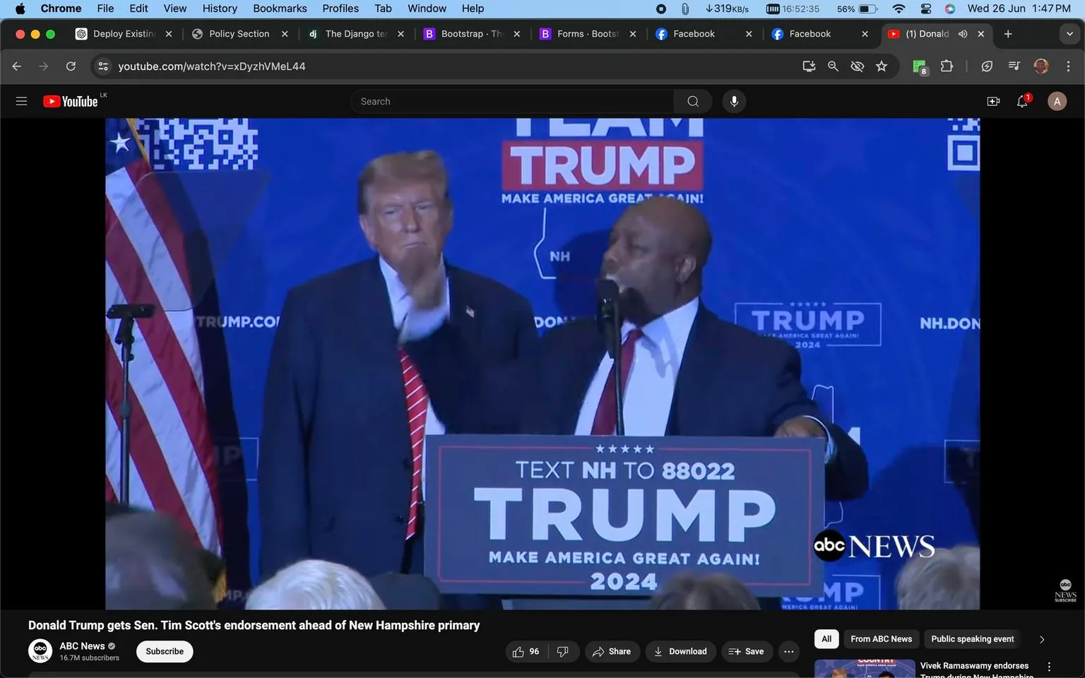 Donald Trump and Tim Scott are featured in this video frame from a political event. Donald Trump stands on the left, wearing a dark suit, a white shirt, and a red striped tie. He appears to be listening intently. To his right, Tim Scott is speaking at a podium, gesturing with his hand. Tim Scott is dressed in a dark suit and red tie. The background is a blue banner with the words "TEAM TRUMP" and "MAKE AMERICA GREAT AGAIN!" prominently displayed, with a QR code visible in the top left corner near an American flag.
The podium features text directing people to "TEXT NH TO 88022" and prominently displays "TRUMP 2024" in large letters. The mood appears formal and serious, typical of a political endorsement setting. The event is covered by ABC News, and the frame captures a moment during a speech or announcement related to the New Hampshire primary. The lighting is bright, providing clear visibility of the participants and background. The image is captured from a YouTube video, as indicated by the browser interface and video title.
- Title: "Donald Trump gets Sen. Tim Scott's endorsement ahead of New Hampshire primary"
- Channel / profile: "ABC News"
- Site / app: "YouTube"