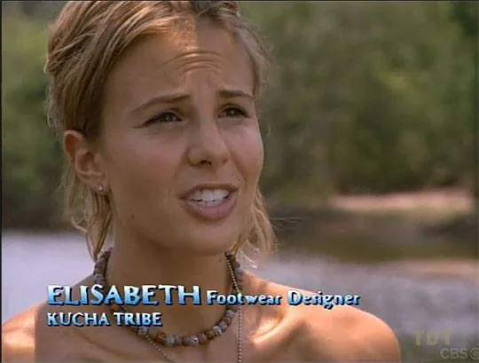 ```
Elisabeth Hasselbeck is featured in this outdoor interview scene from the television show "Survivor," as indicated by the on-screen text and context. The backdrop is a natural setting with blurred greenery and water, indicating a location in the wilderness, typical for "Survivor." Elisabeth is centered in the frame, with sunlight casting natural shadows on her face. She appears to be speaking, with a thoughtful expression.
Elisabeth’s attire is casual, suited for the rugged environment of the show, and she’s wearing a beaded necklace. Her hair is tied back, suggesting practicality and comfort. The on-screen text displays her name, occupation as a "Footwear Designer," and her affiliation with the "KUCHA TRIBE," reinforcing her role and context within the show. The overall color palette is natural, with earthy tones dominating the scene, matching the outdoor setting and contributing to the show's authentic, survivalist atmosphere.
- Title: "Survivor"
- Publisher / studio: "CBS"
- Key OCR lines: "ELISABETH", "Footwear Designer", "KUCHA TRIBE"