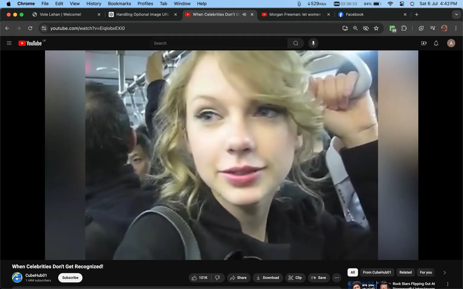 The image is a video frame from YouTube titled "When Celebrities Don't Get Recognized!" The channel name is CubeHub01. The scene takes place inside a crowded public transit vehicle where a person, identified by the hint as Taylor Swift, is standing. She is holding onto a handrail, suggesting she is riding a subway or bus. Her posture is relaxed, and she appears to be engaging in conversation or observing her surroundings with a slight smile. The lighting is typical of indoor public transport, with a neutral color palette and standard overhead lighting. Around her, other passengers can be seen, but they seem uninterested or unaware of her presence. The image captures a candid moment, highlighting the theme of celebrities blending into everyday situations. There are no captions or subtitles visible in the frame.
- Title: "When Celebrities Don't Get Recognized!"
- Channel / profile: "CubeHub01"
- Site / app: "YouTube"