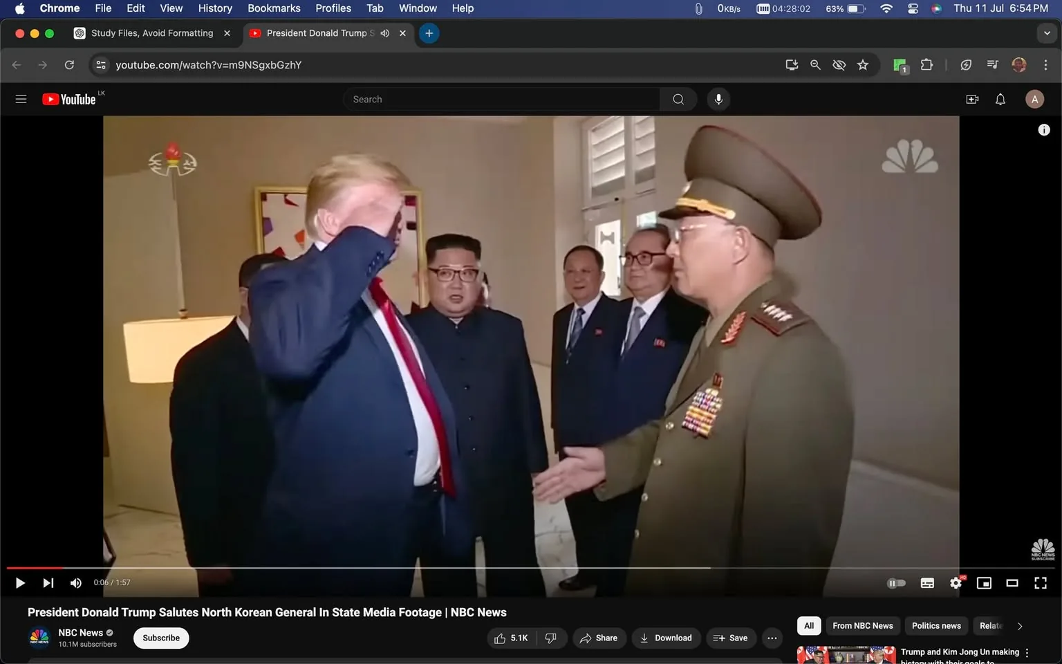 In this screenshot from a YouTube video, the setting appears to be a diplomatic meeting indoors. The scene captures a moment where President Donald Trump is saluting a North Korean general, who is extending his hand for a handshake. Both individuals are in the foreground, with President Trump wearing a dark suit and a red tie, and the general in a military uniform adorned with numerous badges. The background features other individuals, including a man resembling Kim Jong Un, standing alongside two others in suits, indicating a formal environment. The lighting is bright, casting an even tone across the room. The video is hosted on NBC News's channel, as indicated by the watermark and the title at the bottom of the screen. The visual elements suggest a formal diplomatic encounter, highlighting themes of international relations and protocol.
- Title: "President Donald Trump Salutes North Korean General In State Media Footage | NBC News"
- Channel / profile: "NBC News"
- Site / app: "YouTube"