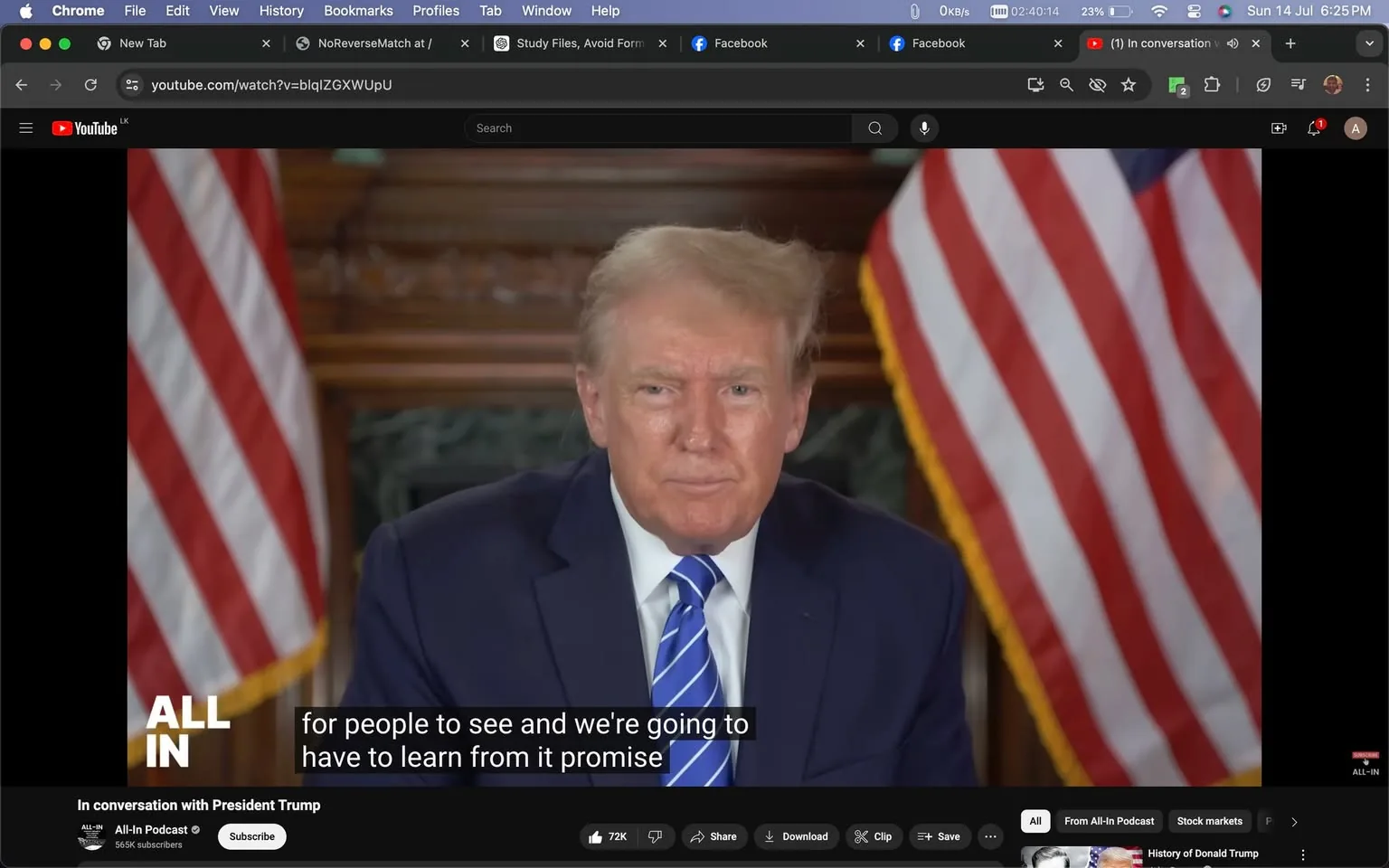 Donald Trump is featured in this video frame from a YouTube video titled "In conversation with President Trump," hosted on the "All-In Podcast" channel. He is centrally positioned, wearing a dark blue suit, a white shirt, and a blue striped tie, exuding a formal and serious demeanor. His expression is thoughtful, complementing the interview setting. The background includes two American flags on either side, adding a patriotic touch to the setting. The room's decor suggests a formal and possibly governmental environment, with a wooden backdrop visible behind him. The lighting is even, highlighting Donald Trump’s facial features and attire. Subtitles at the bottom of the screen read, "for people to see and we're going to have to learn from it promise," indicating a moment in the conversation where he is likely discussing a reflective or forward-looking topic. The video is accessible on YouTube, as indicated by the visible browser elements and the platform's interface.