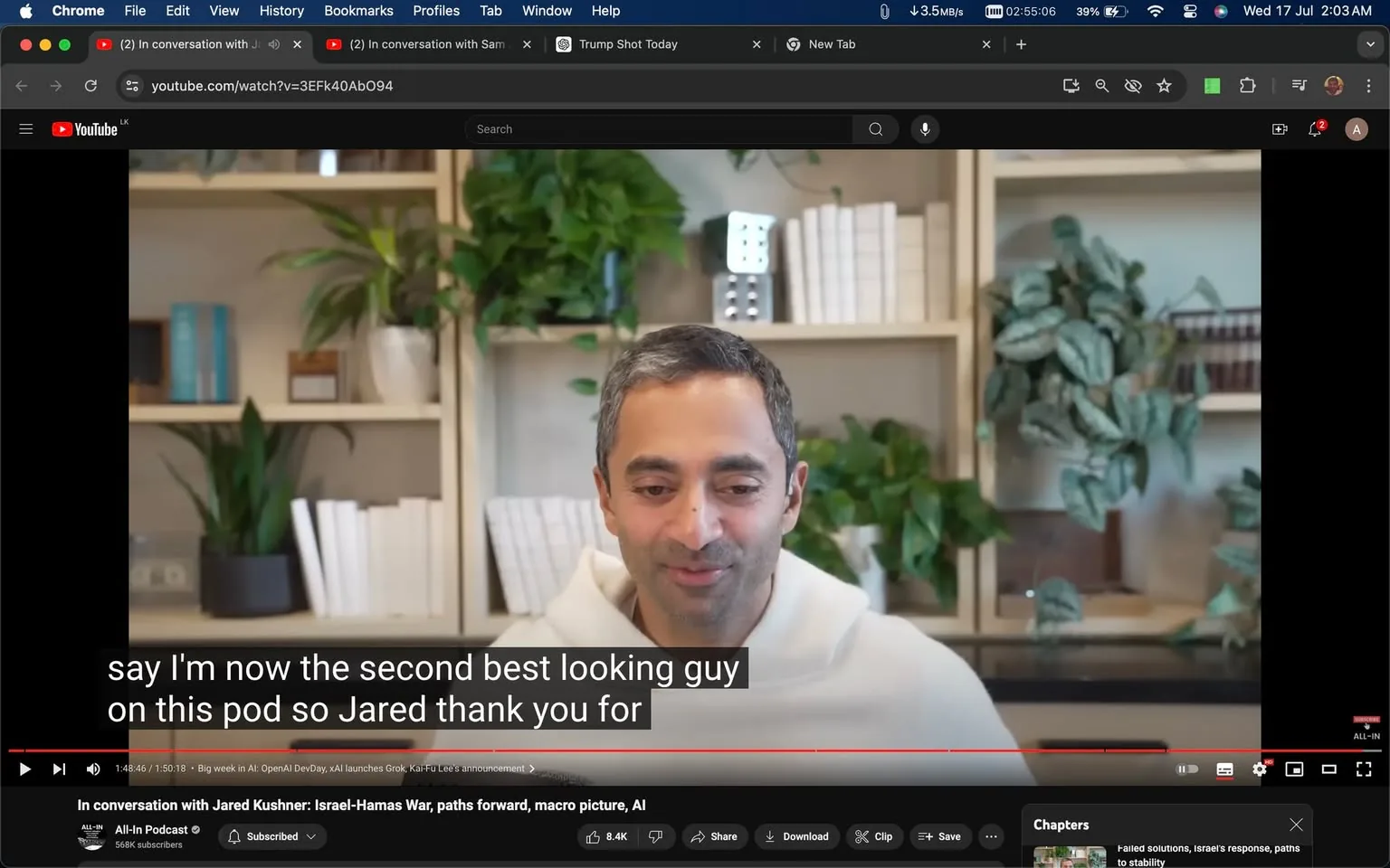 The image is a video frame from a YouTube interview titled "In conversation with Jared Kushner: Israel-Hamas War, paths forward, macro picture, AI" on the All-In Podcast channel. Chamath is the person in the frame, sitting in a well-lit indoor setting. He is wearing a light-colored hoodie and is positioned in front of neatly arranged bookshelves filled with books and decorative plants, adding a cozy backdrop to the scene. Chamath appears engaged, with a slight smile, contributing to a relaxed and conversational atmosphere.
The on-screen text at the bottom includes captions from the video, stating, "say I'm now the second best looking guy on this pod so Jared thank you for." This suggests a lighthearted moment in the discussion. The YouTube interface is visible, with options like "Like," "Dislike," "Share," "Download," and "Clip" below the video, indicating it is currently playing. The browser tabs and address bar at the top show additional open tabs and the URL of the video.