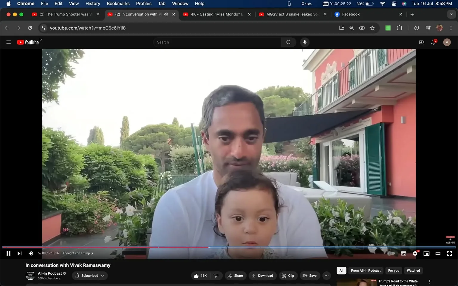 The video frame captures a moment from the "All-In Podcast" on YouTube titled "In conversation with Vivek Ramaswamy." The scene shows Chamath sitting outdoors with a child on his lap. They are in a garden setting, surrounded by lush greenery and flowering plants, which creates a serene and picturesque backdrop. Chamath is wearing a light-colored shirt, and his expression appears calm and relaxed. The child in front of him looks directly at the camera with a curious expression.
Behind them is a charming building with red walls and green shutters, adding a vibrant touch to the scene. The lighting is natural, suggesting it is daytime, enhancing the vivid colors of the plants and the building. The composition is intimate, focusing on the bond between Chamath and the child, suggesting a casual and personal atmosphere typical of a podcast conversation.
- Title: "In conversation with Vivek Ramaswamy"
- Channel / profile: "All-In Podcast"
- Site / app: "YouTube"