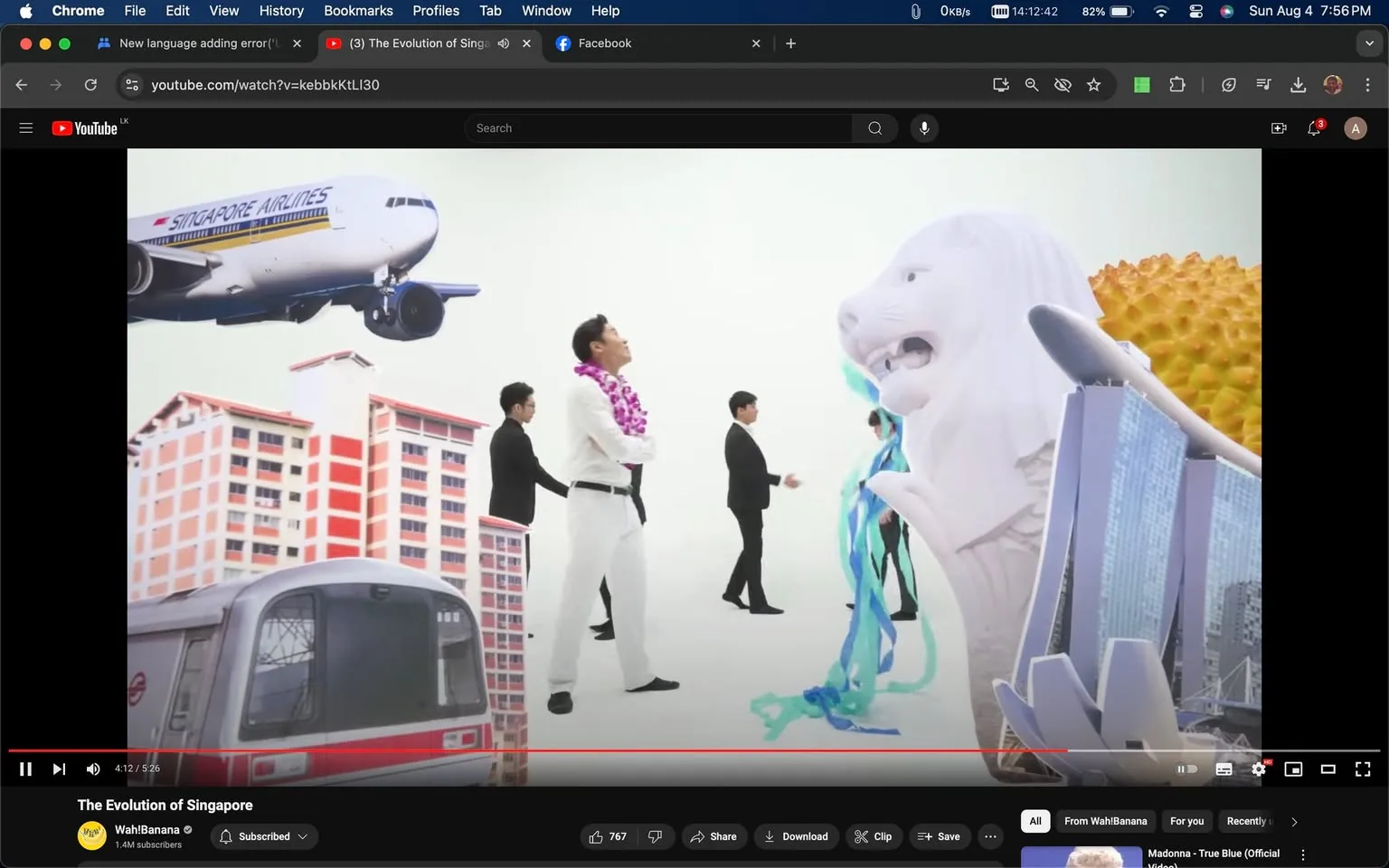 ```
The video frame is from a YouTube video titled "The Evolution of Singapore" on the Wah!Banana channel. It showcases a collage of iconic symbols of Singapore, capturing a vibrant and busy scene. In the foreground, several individuals are dressed in formal attire, with one person notably wearing a white suit and a purple floral lei, suggesting a celebratory or formal occasion.
In the background, various symbolic elements of Singapore are visible. A Singapore Airlines plane is prominently flying, symbolizing the country's renowned airline industry. Adjacent to this, a depiction of a traditional Housing and Development Board (HDB) block represents the urban residential landscape. In the center, the Merlion statue—a national icon of Singapore—is illustrated with its characteristic water spout, adding a touch of national pride. Next to it, the Marina Bay Sands building is visible, another architectural marvel associated with Singapore’s modern skyline. A durian, a widely recognized fruit in Southeast Asia, adds a cultural touch. The MRT train at the bottom signifies Singapore's efficient public transport system.
The overall composition is colorful and dynamic, reflecting Singapore’s blend of tradition and modernity.