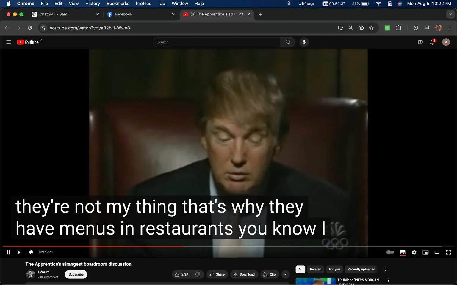 The image is a video frame from a YouTube video titled "The Apprentice's strangest boardroom discussion" on the channel LWes2. It features a scene from "The Apprentice" with Donald Trump. The setting appears to be an indoor boardroom, with dim lighting creating a serious and focused atmosphere. Donald Trump is sitting in a high-backed chair, appearing contemplative or serious, possibly during a moment of decision-making in the show. He is wearing a dark suit and a tie, consistent with the formal setting of the boardroom discussions in "The Apprentice." The frame includes captions at the bottom, displaying the text: "they're not my thing that's why they have menus in restaurants you know I." The YouTube interface is visible, including the browser tabs and video controls. The scene captures the essence of a pivotal or unusual boardroom conversation, typical of the show's dramatic moments. The NBC logo is faintly visible, indicating the network associated with the show.