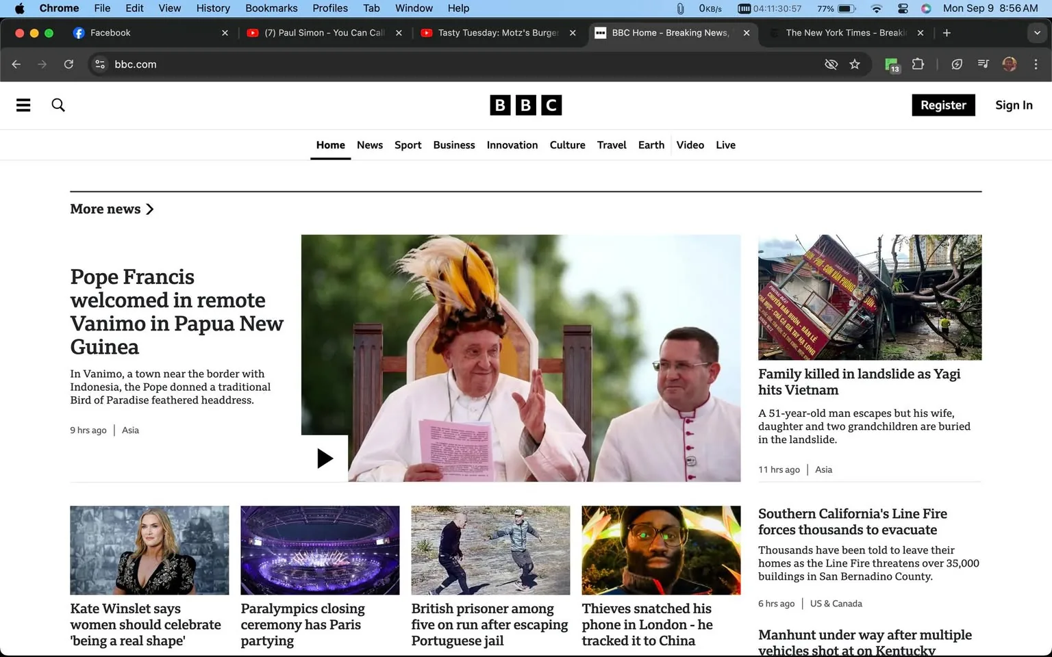 The screenshot is from the BBC website, showing the homepage with a prominent headline about Pope Francis being welcomed in Vanimo, Papua New Guinea. The image associated with the headline shows Pope Francis wearing a traditional Bird of Paradise feathered headdress, sitting on a chair, holding a paper, and making a gesture with his hand. Beside him, another clergy member is dressed in a white robe with red accents, looking towards the Pope. The background is softly blurred, emphasizing the subjects.
Adjacent to this main story, there is a smaller image showing the aftermath of a landslide in Vietnam, with a damaged structure and uprooted trees. The headline reads "Family killed in landslide as Yagi hits Vietnam."
Below these headlines, additional stories are featured, including Kate Winslet discussing body image, the closing ceremony of the Paralympics, and a story about a British prisoner escaping from a Portuguese jail. The layout is clean and structured, with the BBC logo at the top center and navigation links for different sections like Home, News, and Sport.
The page also shows open tabs in the browser, including a Facebook tab and a YouTube video titled "Paul Simon - You Can Call Me Al." The browser's design is typical of Google Chrome, with options like File, Edit, and View visible in the menu bar.
