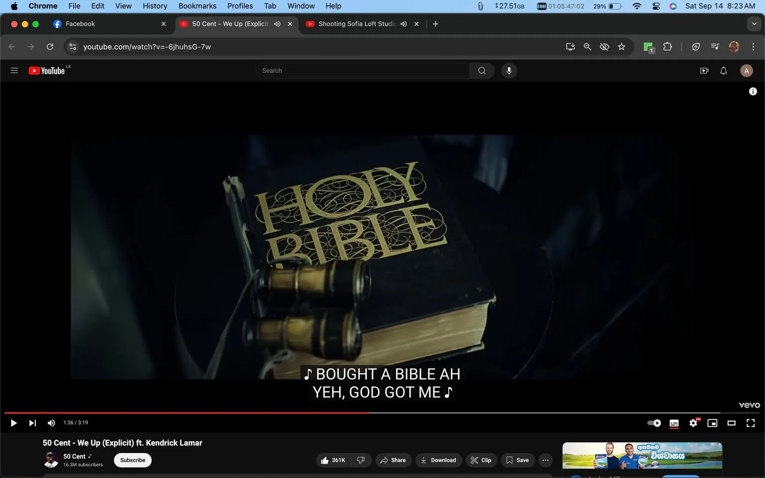 The video frame shows a scene from the music video titled "We Up" by 50 Cent, featuring Kendrick Lamar. The setting appears to be indoors with dim lighting, creating a somber and reflective mood. In the foreground, a "Holy Bible" is prominently placed on a table, with its title embossed in gold lettering, indicating its significance in the scene. Next to the Bible, a pair of binoculars rests, an intriguing juxtaposition that might symbolize searching for truth or guidance. The colors in the scene are muted, focusing primarily on the dark tones of the table and the deep gold of the Bible's lettering. The screenshot includes subtitles at the bottom, reading: "I BOUGHT A BIBLE AH" and "YEH, GOD GOT ME," suggesting a theme of faith or divine protection. This choice of visual and textual elements might reflect the personal or spiritual undertones of the song. The video is hosted on YouTube, under the official channel of 50 Cent, with the viewer count and like button visible, hinting at its popularity. The image captures a moment that balances between material and spiritual motifs, possibly indicating a narrative of introspection or redemption.