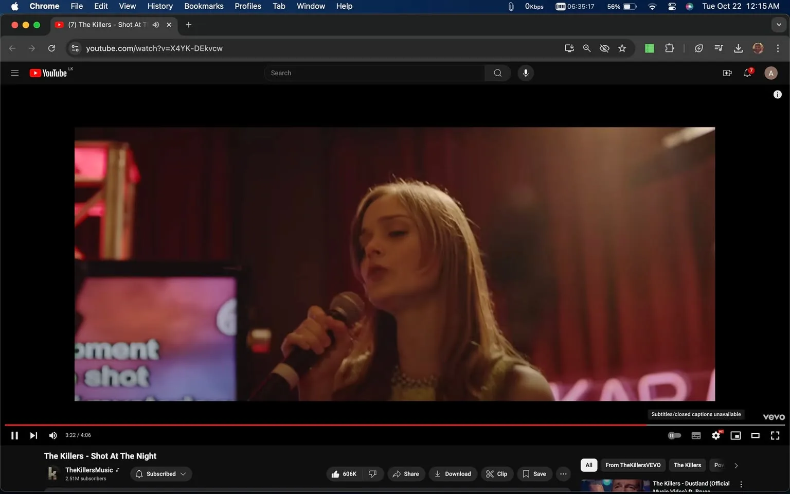 The image is a screenshot from the YouTube music video for "The Killers - Shot At The Night." It displays a scene where a woman is singing into a microphone, suggesting a karaoke setting. The lighting is warm and focused on her, casting a soft glow that adds to the intimate atmosphere of the performance. In the background, there is a partially visible screen with blurred text, possibly showing karaoke lyrics, and a neon sign with the word "KARAOKE" can be partially seen. The woman appears engaged and focused, with a serene expression as she performs. Her attire is casual yet stylish, fitting the laid-back, yet emotionally resonant setting of the video. The composition centers on her, capturing a moment filled with musical passion. The screenshot is from YouTube, evident from the typical video interface and control icons. This scene captures the essence of the music video’s narrative, focusing on personal moments and connections.
- Title: "The Killers - Shot At The Night"
- Channel / profile: "TheKillersMusic"
- Site / app: "YouTube"