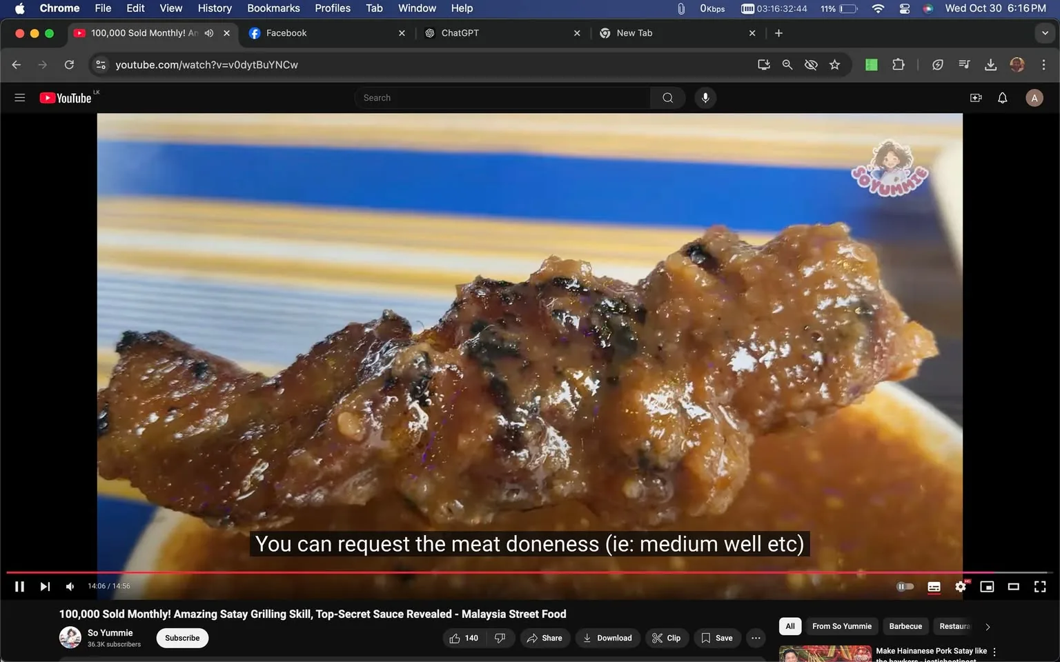 This image is a screenshot from a YouTube video titled "100,000 Sold Monthly! Amazing Satay Grilling Skill, Top-Secret Sauce Revealed - Malaysia Street Food" on the channel "So Yummie." The video appears to be focused on Malaysian street food, specifically satay. The scene shows a close-up of a piece of grilled meat, presumably satay, covered in a glossy, rich sauce. The meat is charred in places, indicating it has been grilled, and the sauce glistens under the lighting. The background features a blurred, striped pattern, possibly part of a dish or tablecloth. The subtitle at the bottom of the screen states, "You can request the meat doneness (ie: medium well etc)," suggesting that viewers can customize the cooking level of the satay. The YouTube interface elements are visible, including the title, channel name, and video controls, giving a sense of active media consumption.