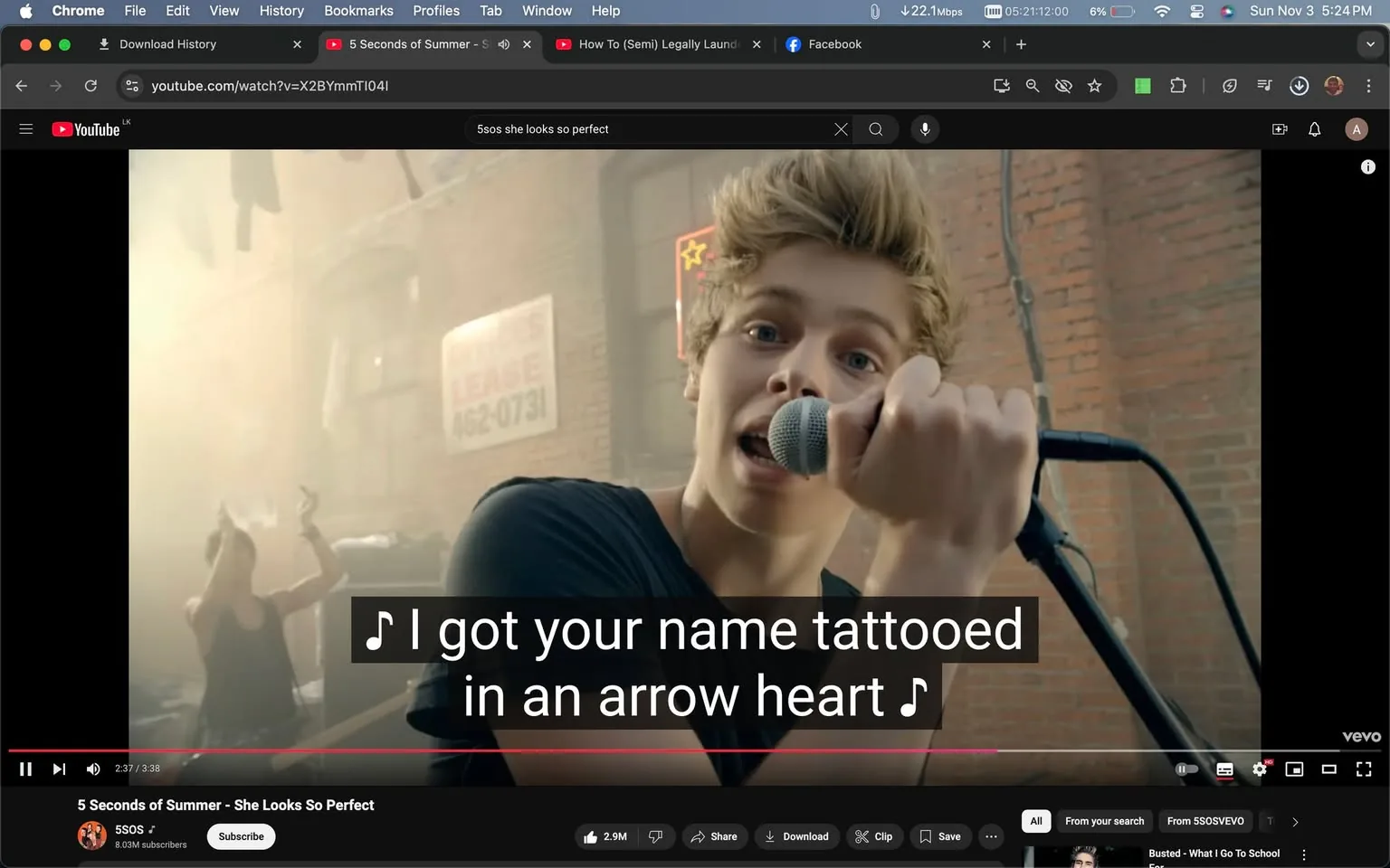 In this image, a scene from the music video "She Looks So Perfect" by 5 Seconds of Summer is featured. The setting appears to be an outdoor location with a brick wall in the background. A member of the band, holding a microphone, is singing directly into the camera, creating an engaging and dynamic performance atmosphere. The artist is dressed casually in a black shirt, embodying a youthful and energetic vibe typical of pop-punk style bands.
The lighting is warm and bright, suggesting a daytime shoot, with sunlight softly illuminating the scene. Behind the singer, a partially visible sign reads "LEAGUE" along with a phone number, adding to the urban backdrop. The image is framed to capture the artist's expressive performance, highlighting the band's charismatic stage presence.
The YouTube interface, including play controls and video title, is visible. The video is from the channel "5SOS," and the title confirms the song "She Looks So Perfect." At the bottom of the screen, captions display lyrics: "I got your name tattooed in an arrow heart," enhancing the viewer's connection to the music. This frame effectively conveys the energetic and personal essence of the band's music and visual style.
- Title: "5 Seconds of Summer - She Looks So Perfect"
- Channel / profile: "5SOS"
- Site / app: "YouTube"
- Captions / subtitles: "♪ I got your name tattooed in an arrow heart ♪"