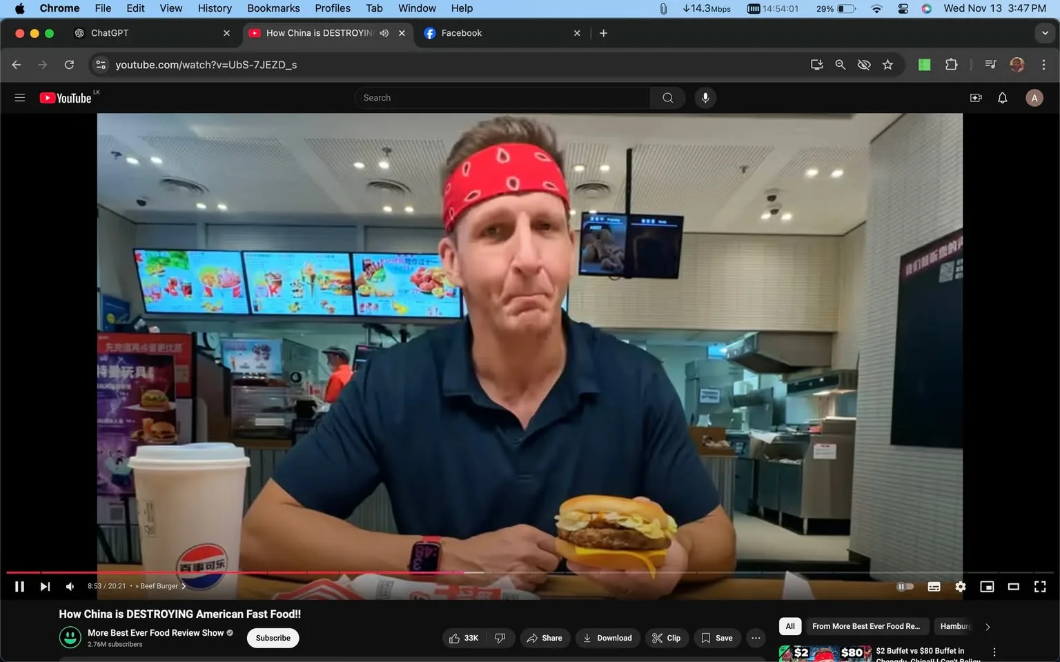 Sonny Side is featured in this YouTube screenshot from the video titled "How China is DESTROYING American Fast Food!!" on the channel "More Best Ever Food Review Show." He is sitting at a table in a fast-food restaurant, holding a burger in his hands. Sonny is wearing a red bandana with white patterns around his head and a navy blue polo shirt. On the table, there is a large paper cup with a logo on it, likely from the restaurant, alongside a wrapped burger. The background shows a typical fast-food counter with menu boards displaying colorful images of various food items. The setting is brightly lit, with modern ceiling lights enhancing the indoor ambiance. The video seems to focus on food tasting, with Sonny examining and possibly preparing to taste the burger in front of him. The setting suggests a casual and engaging food review atmosphere.
- Title: "How China is DESTROYING American Fast Food!!"
- Channel / profile: "More Best Ever Food Review Show"
- Site / app: "YouTube"