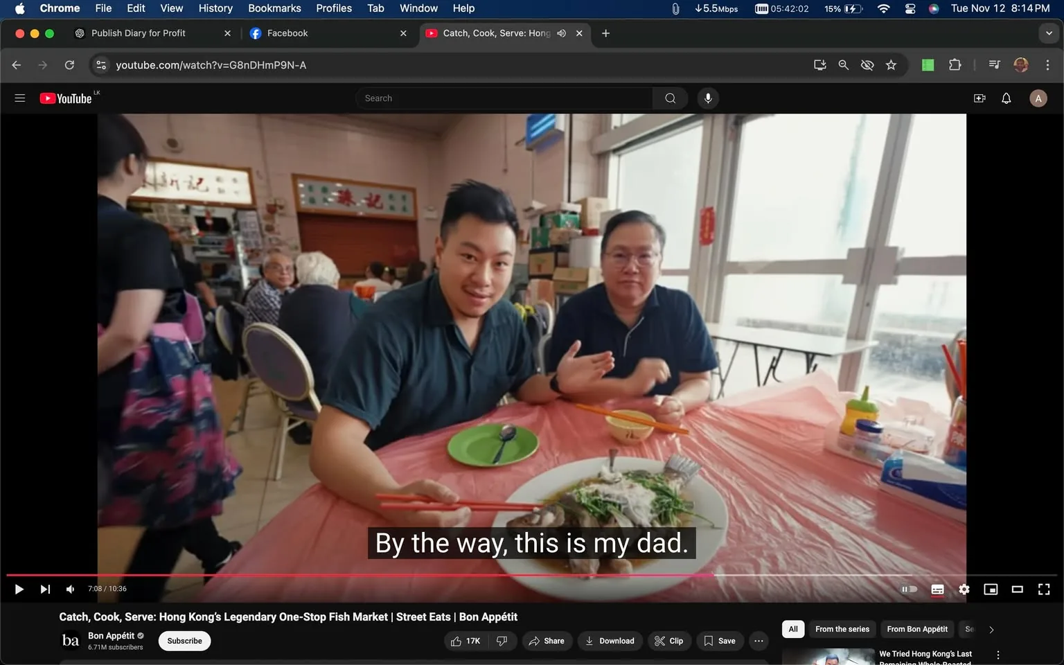 The image is a screenshot from a YouTube video titled "Catch, Cook, Serve: Hong Kong’s Legendary One-Stop Fish Market | Street Eats | Bon Appétit." It features a moment in a dining setting where a father and son are sitting at a table covered with a light pink tablecloth. The son is gesturing towards a dish of fish placed in front of them, with subtitles indicating he is introducing his father. Both are casually dressed in dark shirts and are seated in what appears to be a bustling restaurant with several other patrons visible in the background. The atmosphere is casual and lively, with a mix of natural light coming through large windows. The video is hosted on the Bon Appétit YouTube channel, known for its food-related content. The setting and activity suggest a focus on enjoying and experiencing local cuisine, particularly seafood, in Hong Kong.
- Title: "Catch, Cook, Serve: Hong Kong’s Legendary One-Stop Fish Market | Street Eats | Bon Appétit"
- Channel / profile: "Bon Appétit"
- Site / app: "YouTube"
- Captions / subtitles: "By the way, this is my dad."