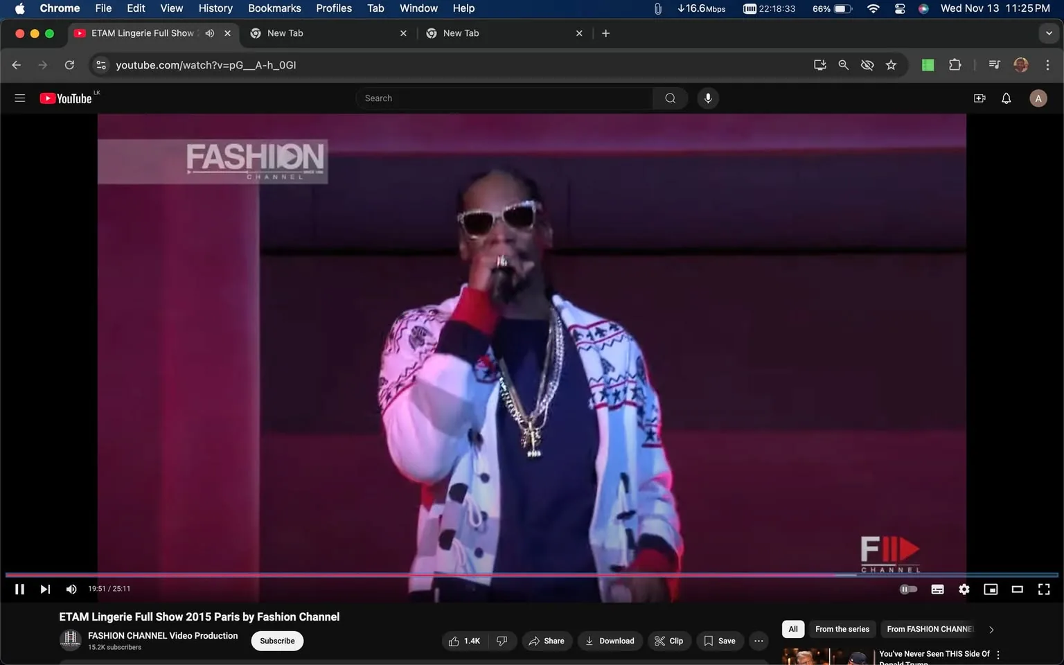 The image is a video frame from YouTube showing a performance by Snoop Dogg. He is on stage during the ETAM Lingerie Full Show 2015 in Paris, as presented by the Fashion Channel. Snoop Dogg is wearing sunglasses and is dressed in a stylish outfit that includes a patterned cardigan with bold red, white, and blue colors. He is holding a microphone and appears to be mid-performance, likely engaging with the audience. The lighting is vibrant, with a pinkish-purple hue in the background, adding a lively atmosphere to the scene. Visible on the screen is the logo "FASHION CHANNEL" in the top left corner, confirming the channel's identity. This setting is typical of a fashion show, combining live music with fashion presentations, enhancing the overall entertainment experience. Snoop Dogg's presence adds a dynamic and high-energy element to the event, which is part of a larger show celebrating fashion and music.